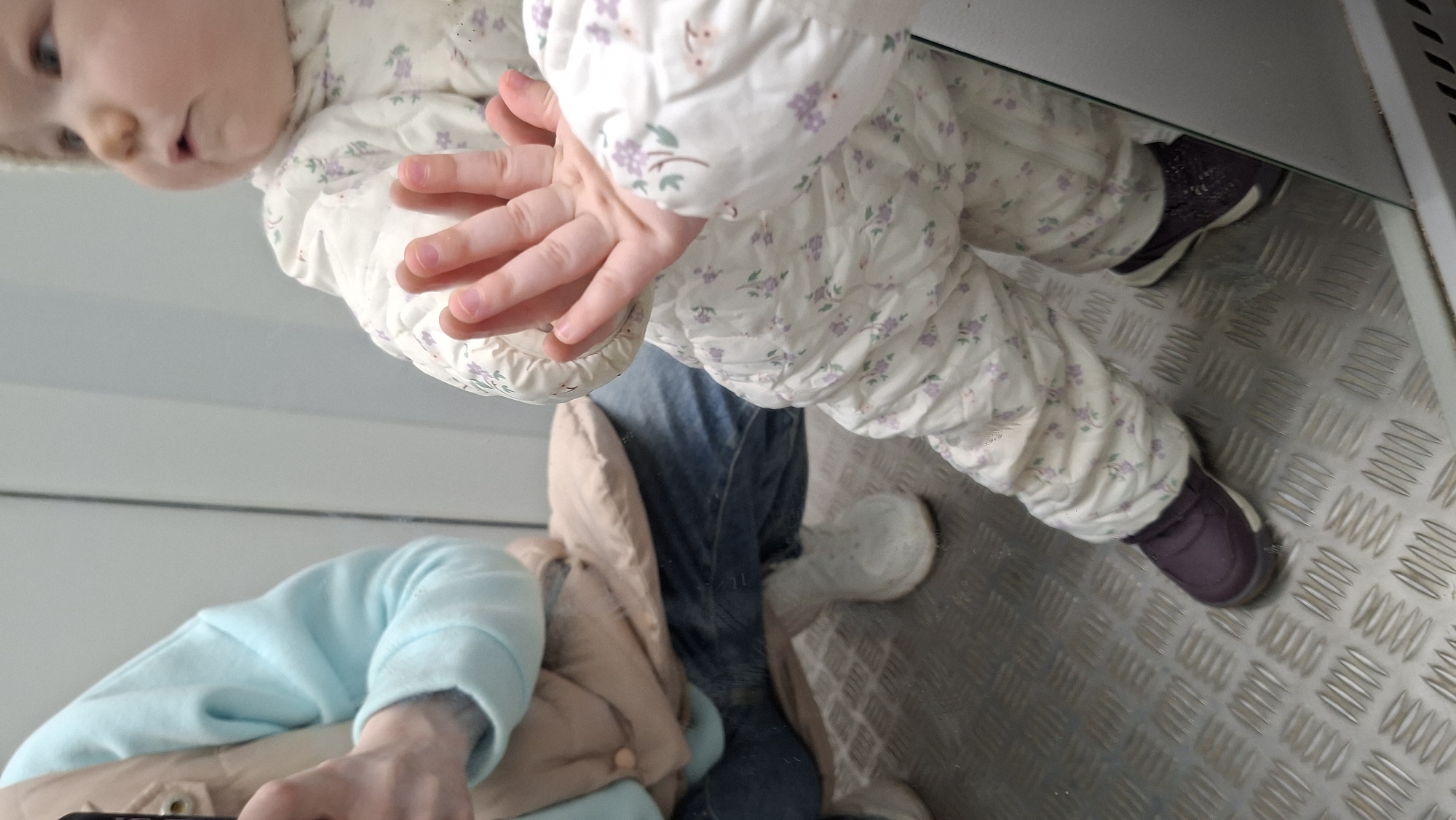 Child and adult captured in reflection image