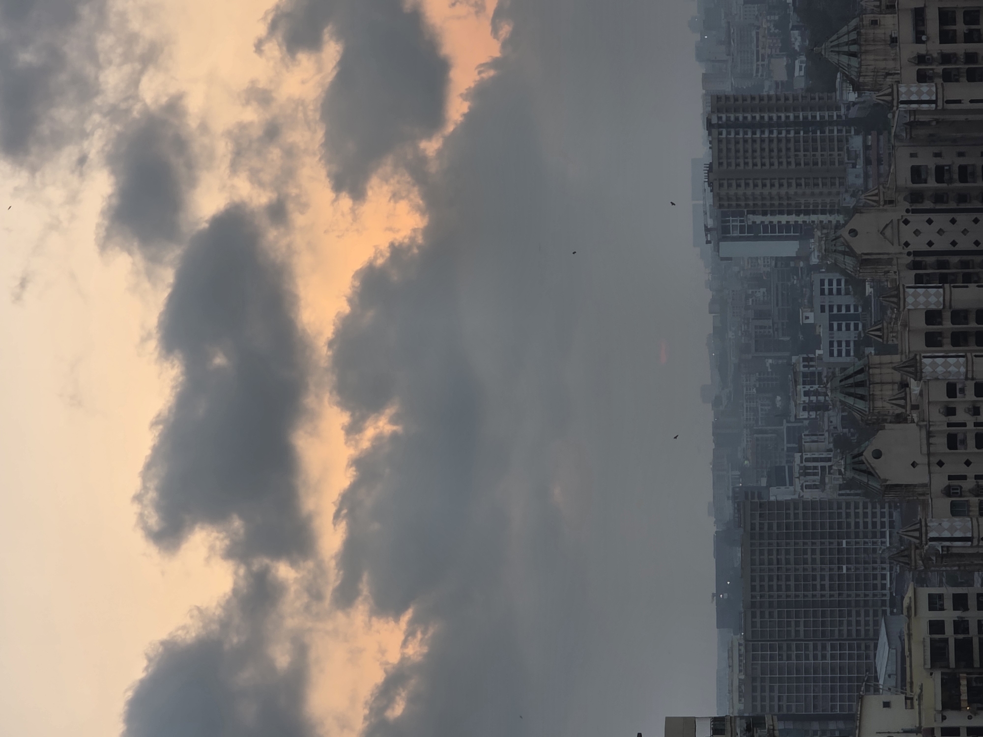 Dramatic sky with orange glow observed over Mumbai cityscape