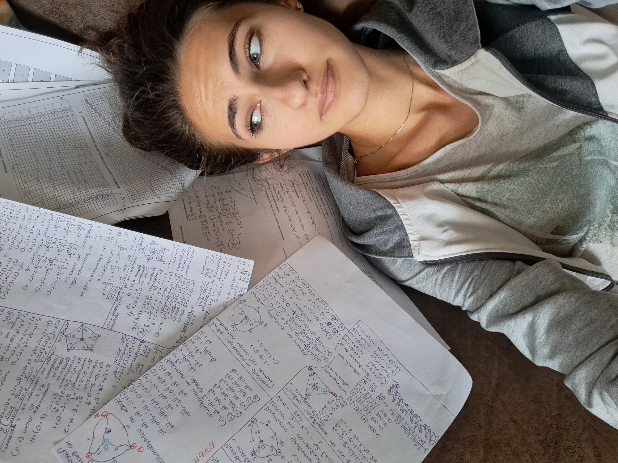 Student studies math equations on couch in Bulgaria