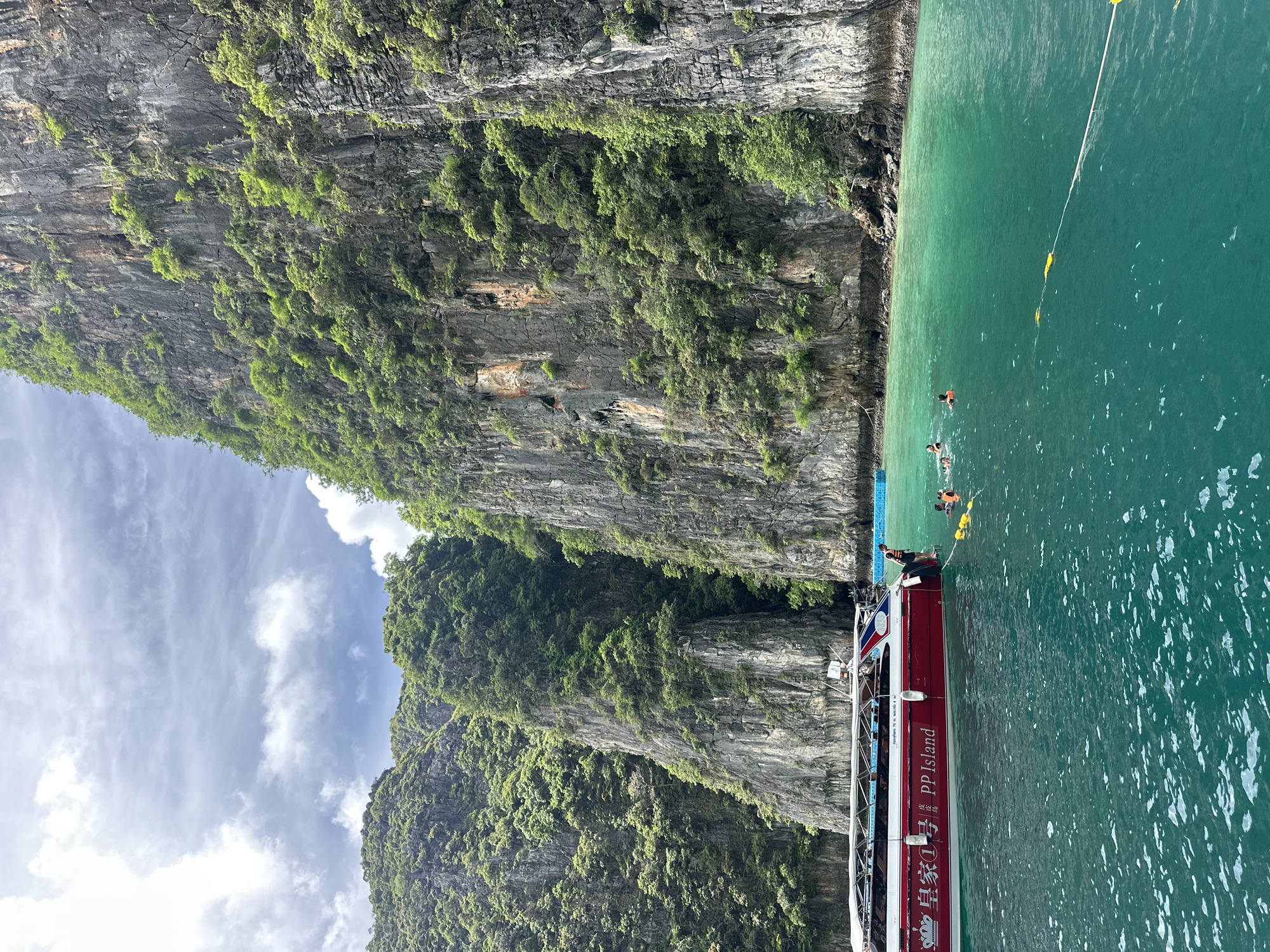 Tour boats and swimmers at Koh Phi Phi Leh's limestone coves