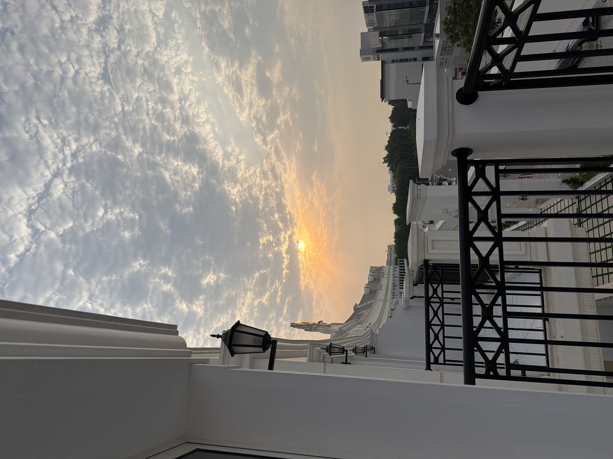 Dubai balcony overlooks cityscape at cloudy sunset