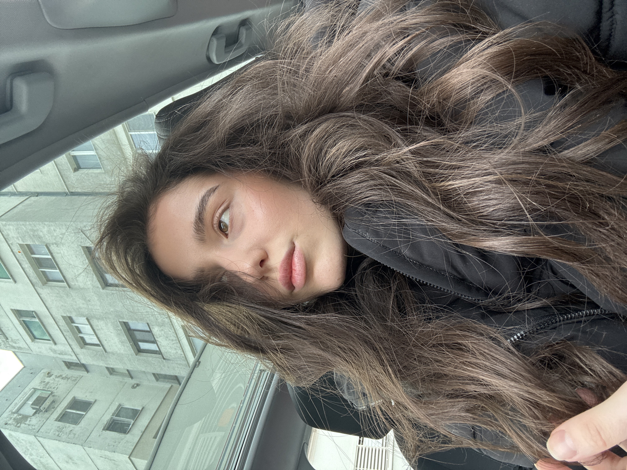 Woman takes car selfies in various positions during morning