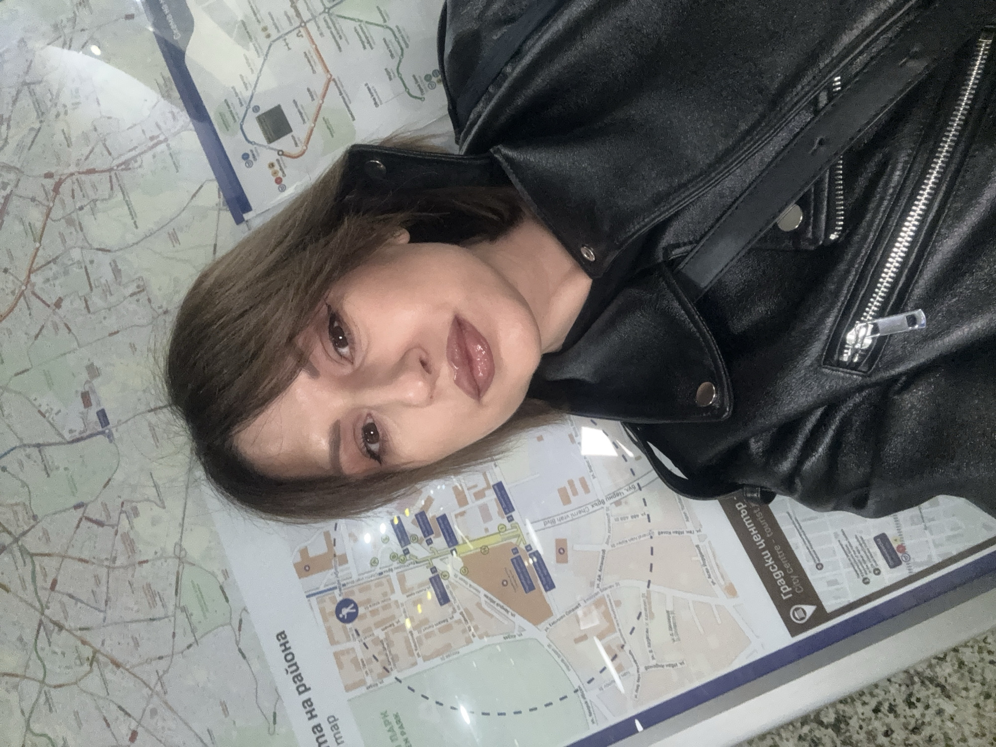 Tourist takes selfies, uses city map in Sofia