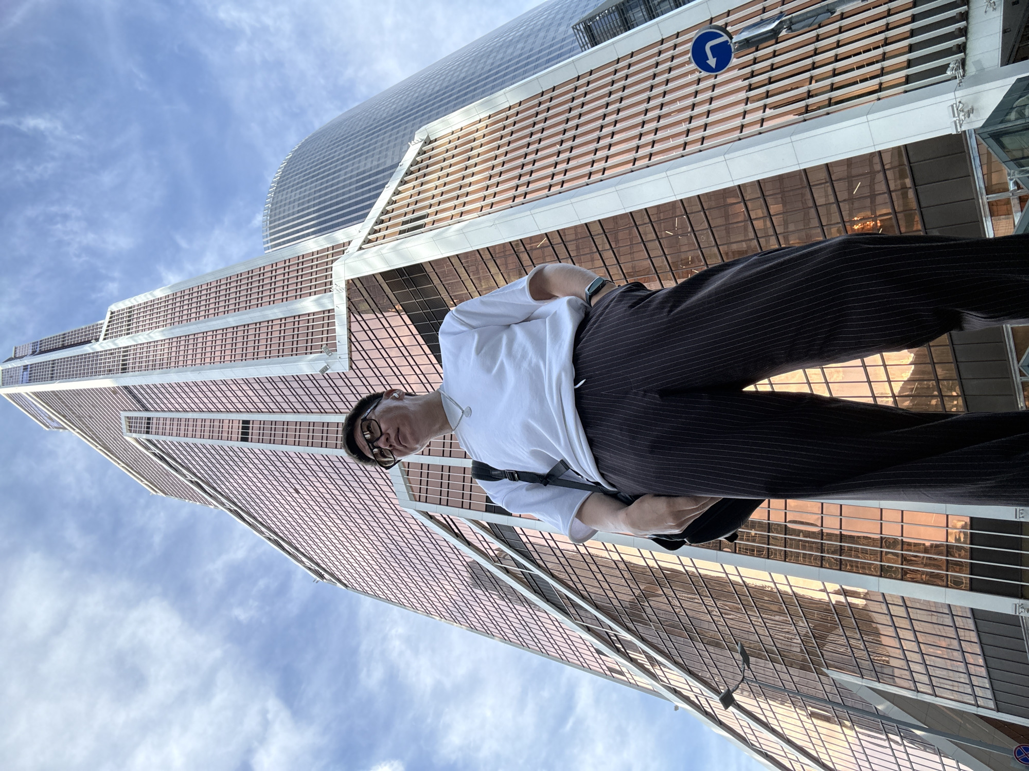 Posed outside a rose-gold glass tower in Khimki