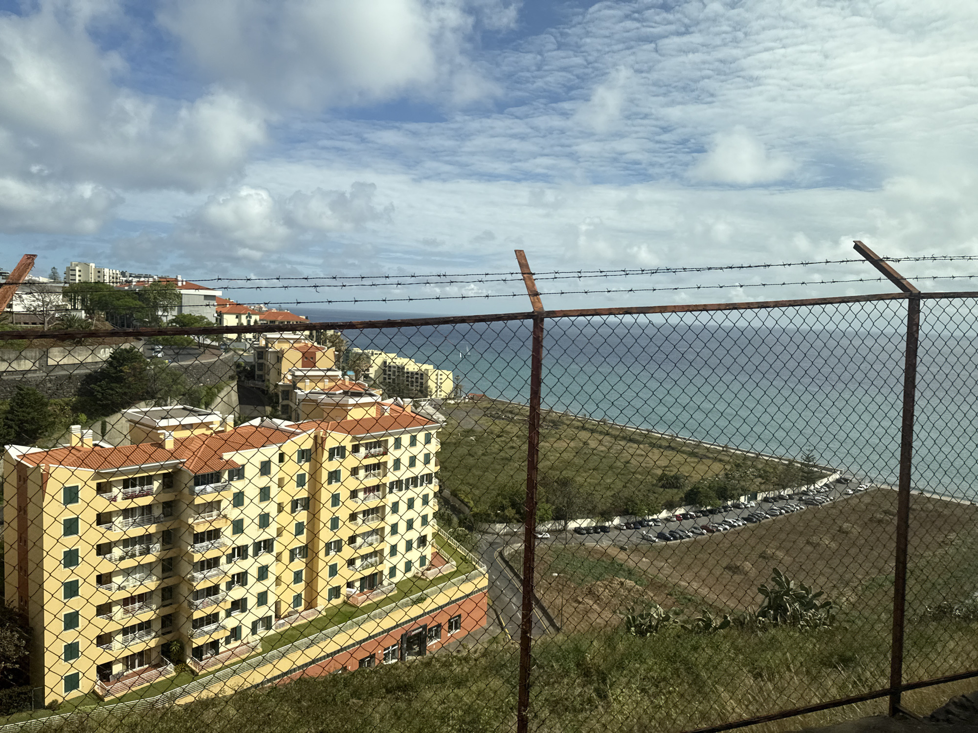 Coastal overlook with yellow building documented in Funchal, Portugal