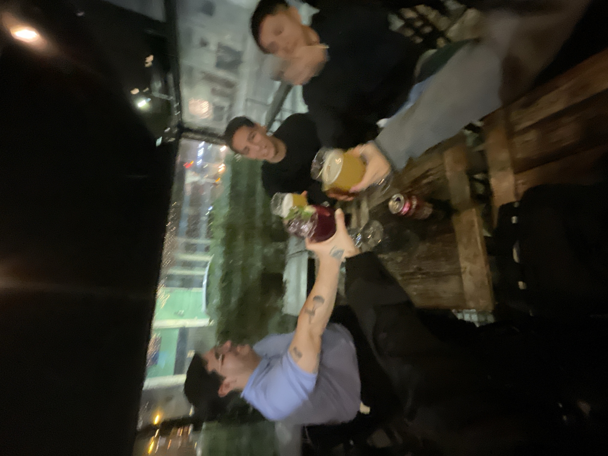 Late night gathering toasts drinks at Buenos Aires establishment