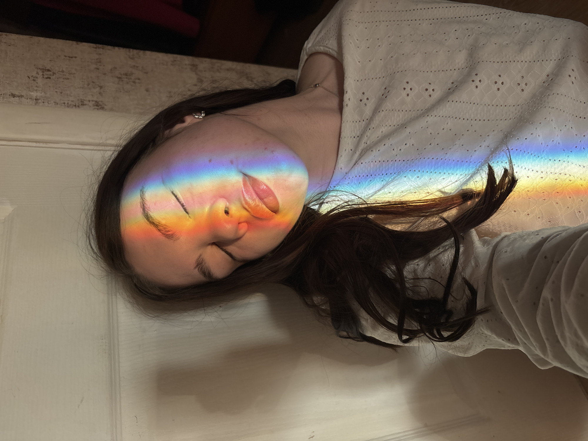 Woman illuminated by rainbow light observed in Perm