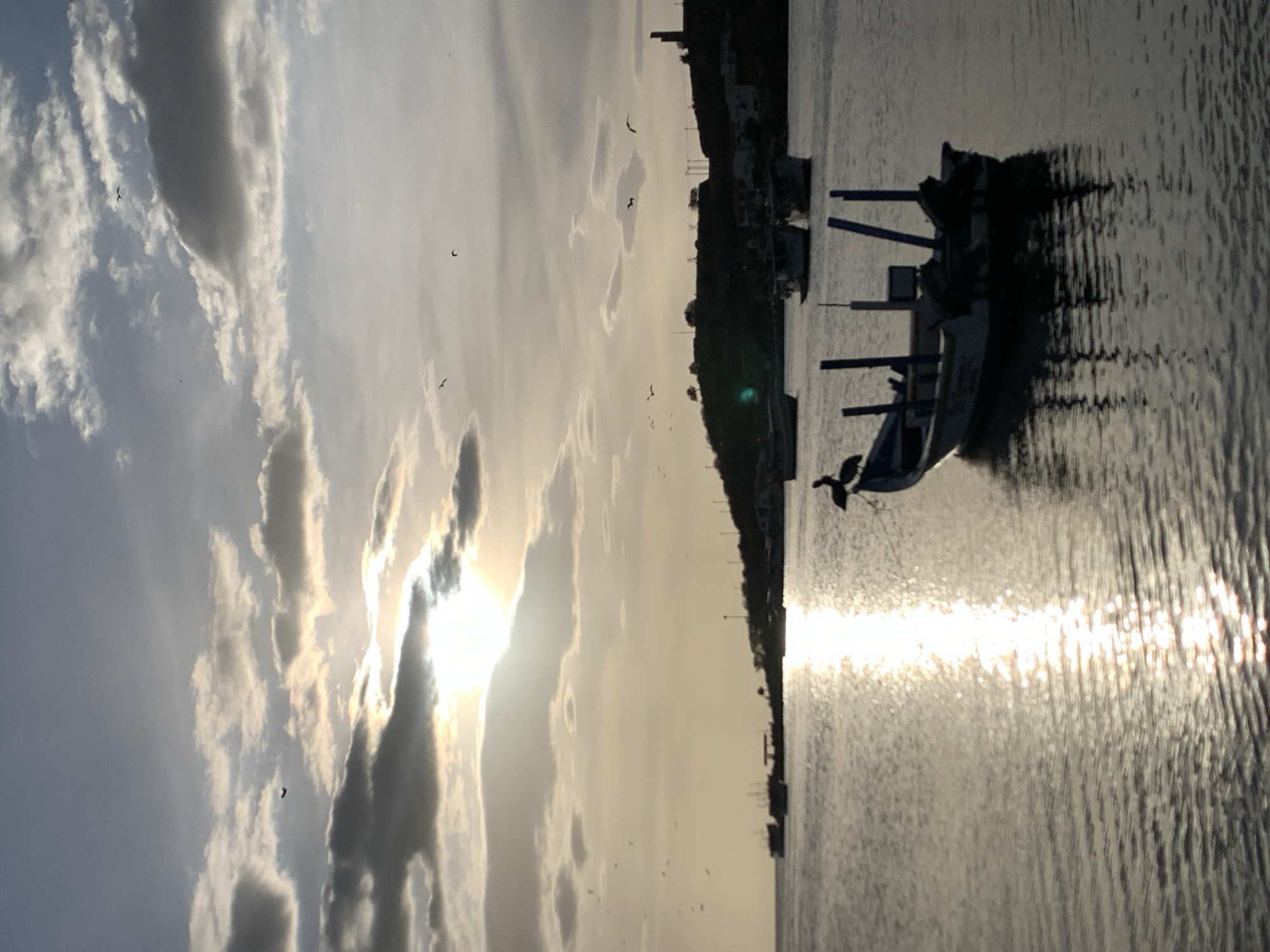 Sunset documented across Juan Griego harbor and streets