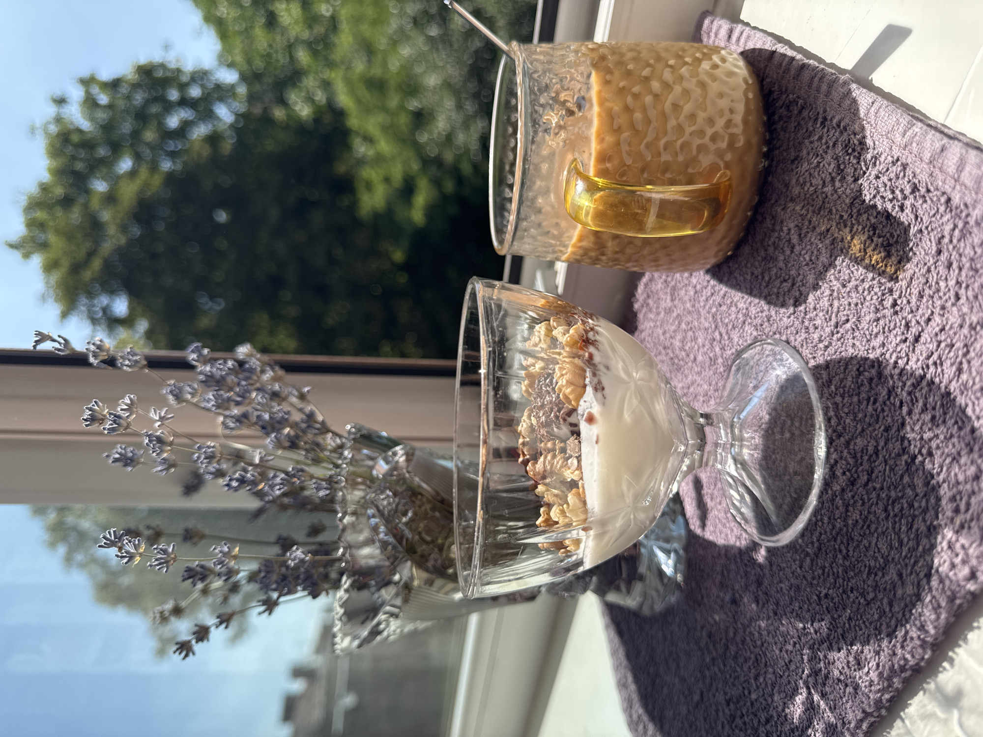 Sunny windowsill breakfast with yogurt, coffee, and dried lavender
