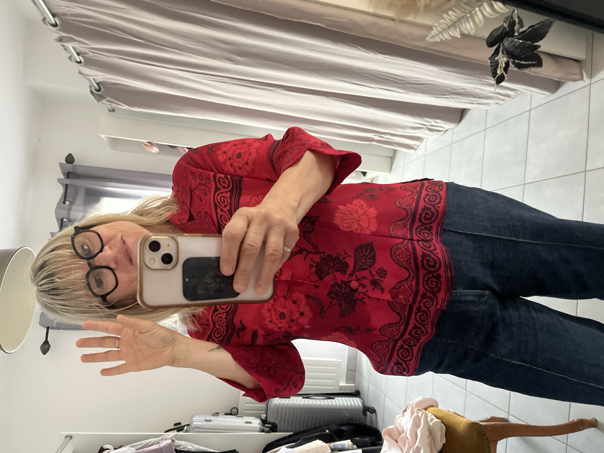 Woman takes mirror selfies in French bedroom
