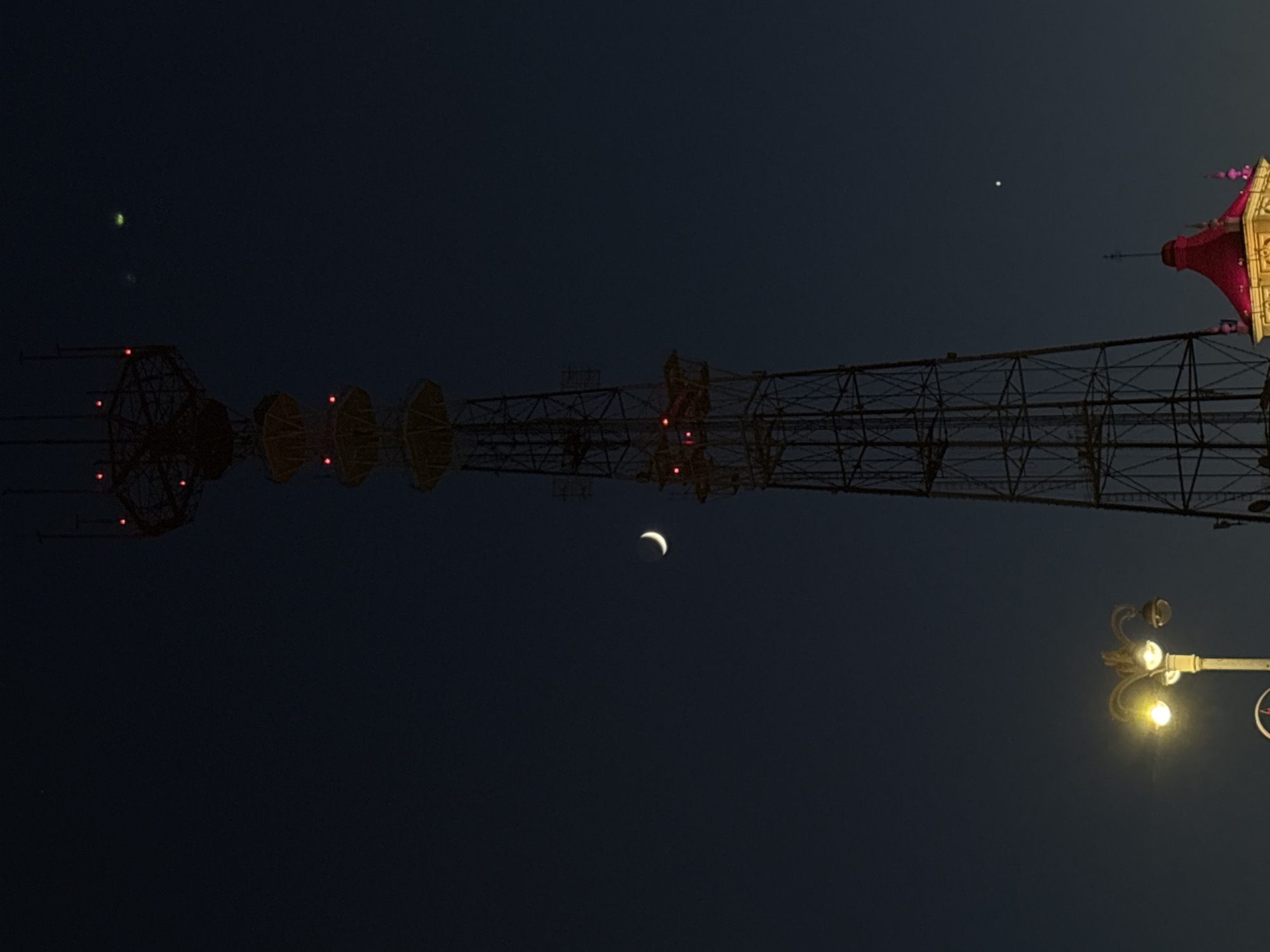 Evening scenes documented across illuminated Minsk under crescent moon