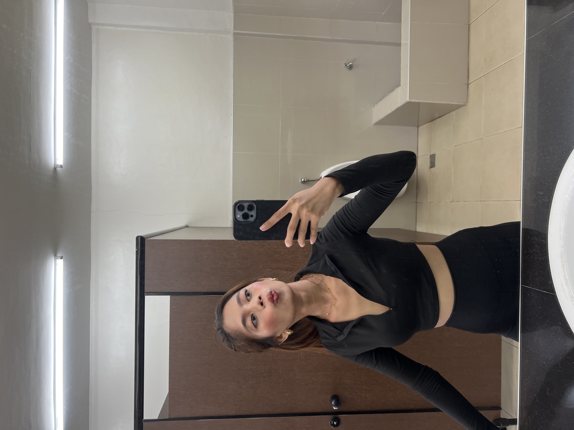 Mirror selfies in a Davao City public restroom, two outfits