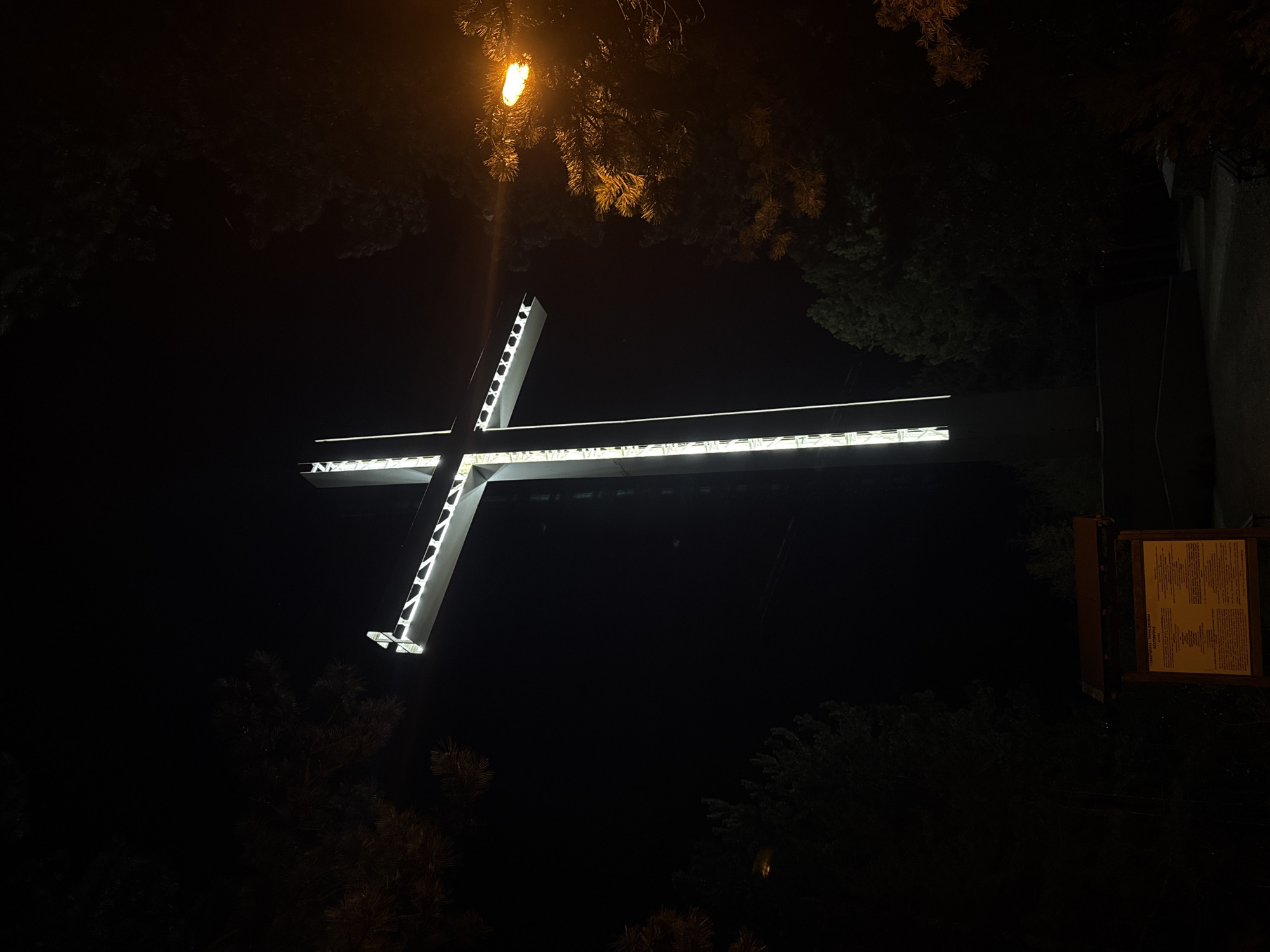 Illuminated cross captured at night in Blagoevgrad, Bulgaria
