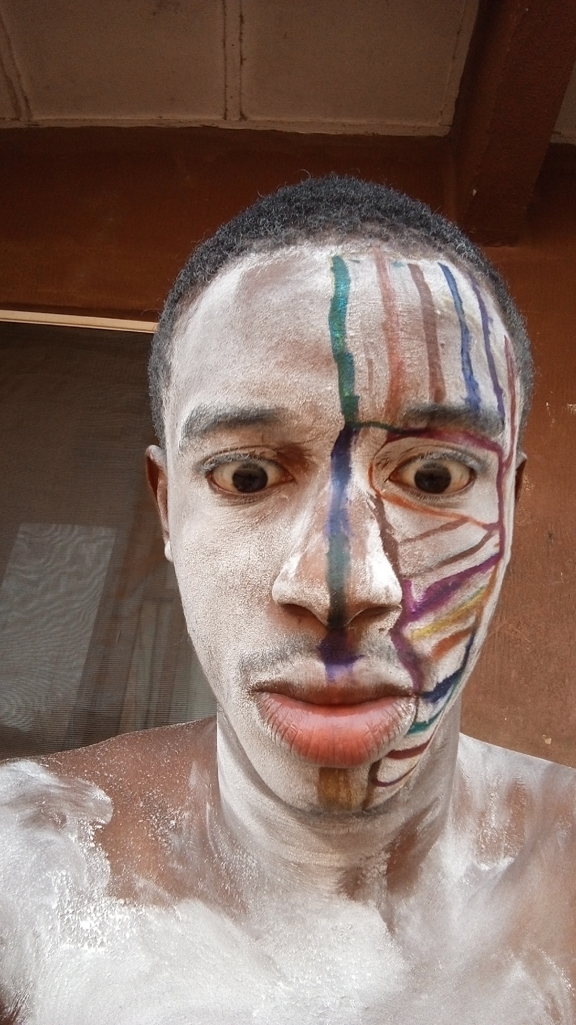 Person observed with ceremonial face paint and white powder