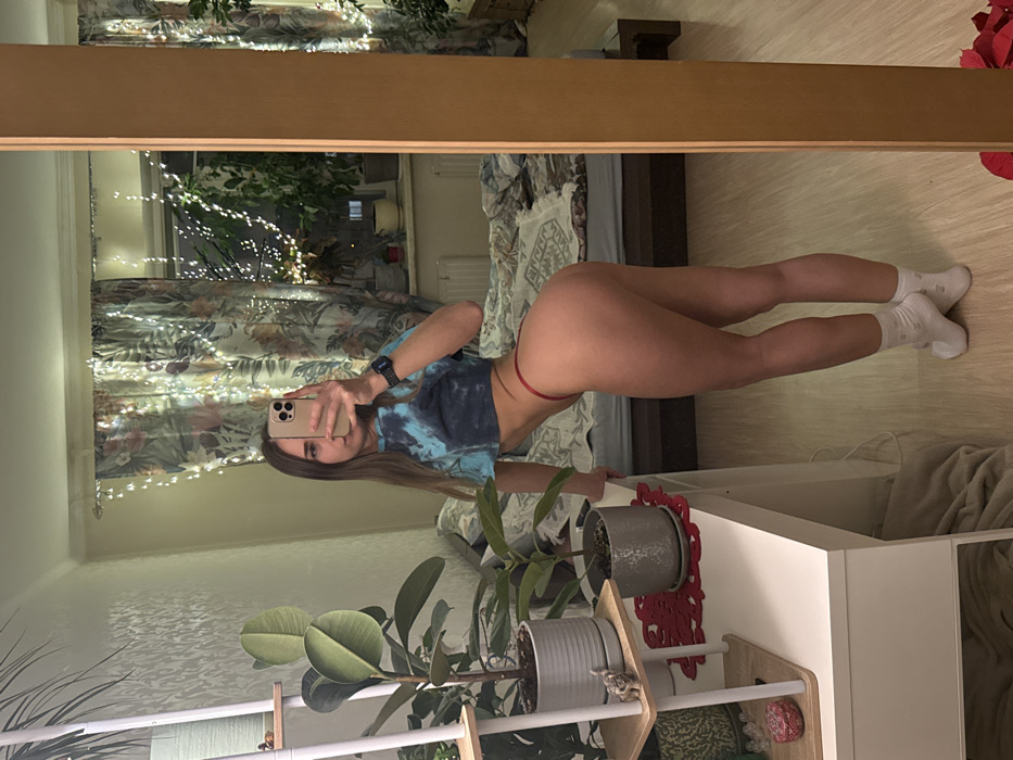 Woman takes multiple mirror selfies in Saint Petersburg bedroom