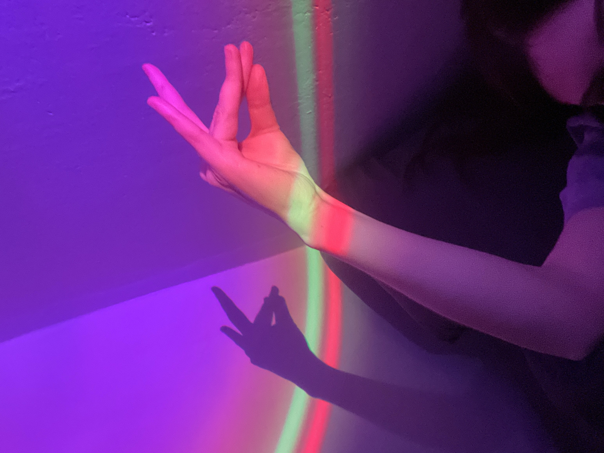 Person experiments with colorful lighting effects indoors in Moscow