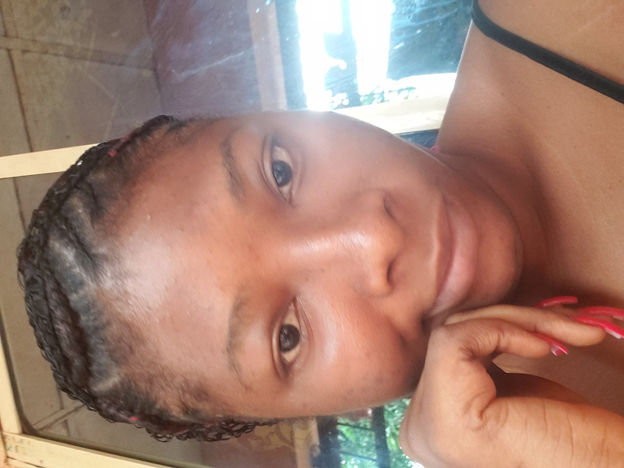 Woman with braids captured in contemplative pose, April 23