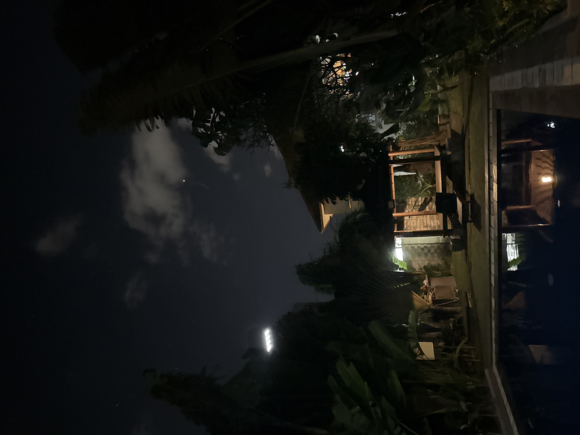 Nighttime poolside and garden scenes at a Bali property