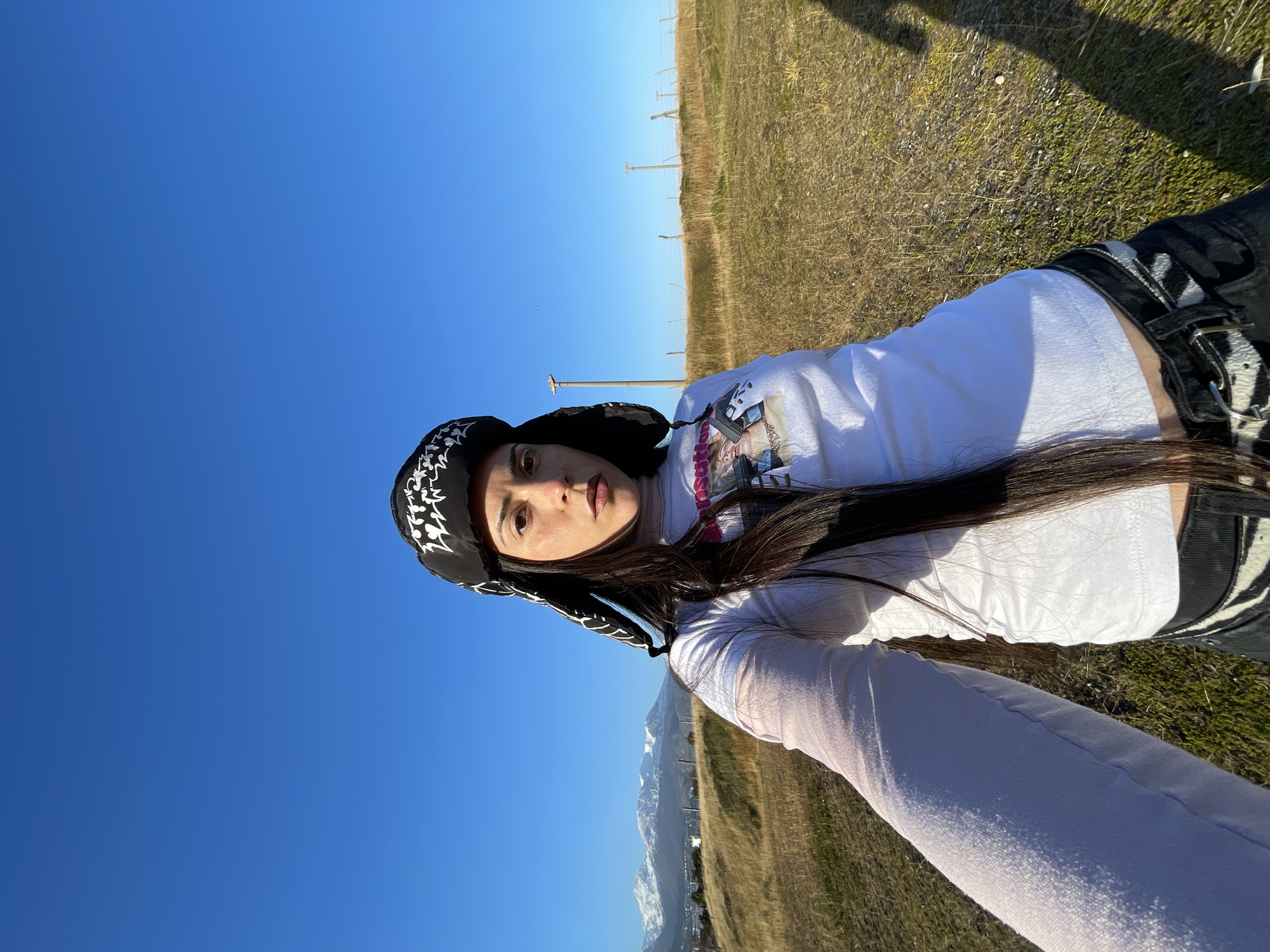 Woman takes outdoor selfie under clear skies in Ushuaia