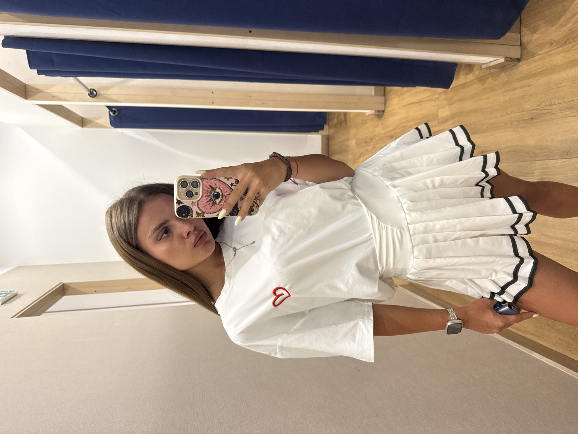 Fitting room try-on session in Plovdiv, white pleated skirt outfit