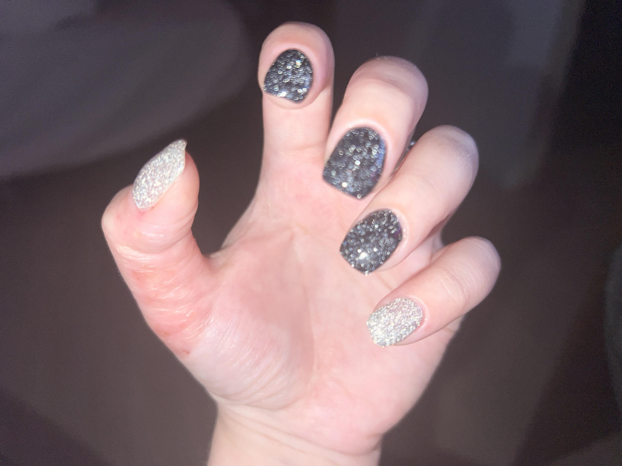 Woman poses for photos with glitter nails in Pushchino