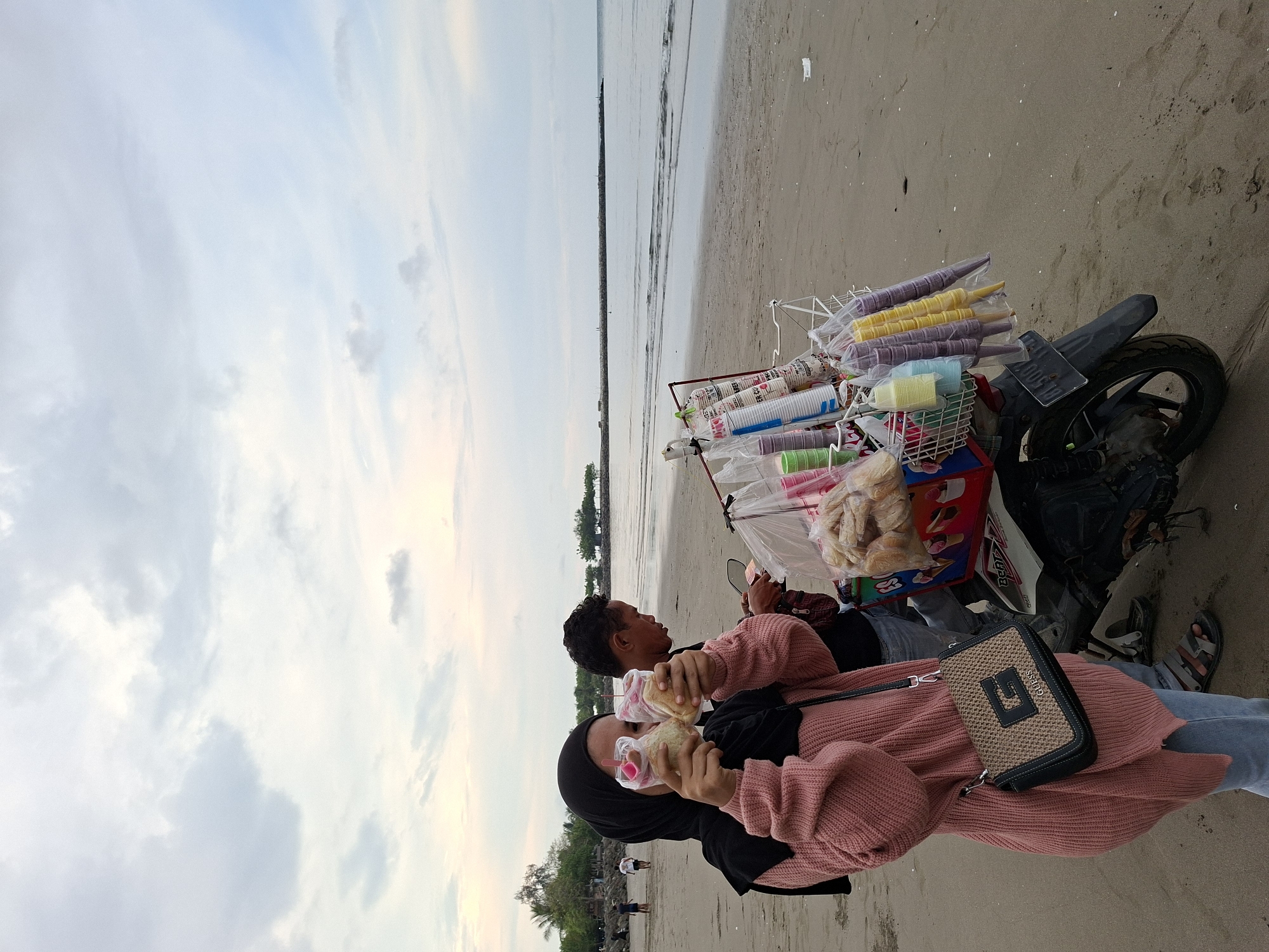 Beach ice cream vendor serves customers in Lhokseumawe