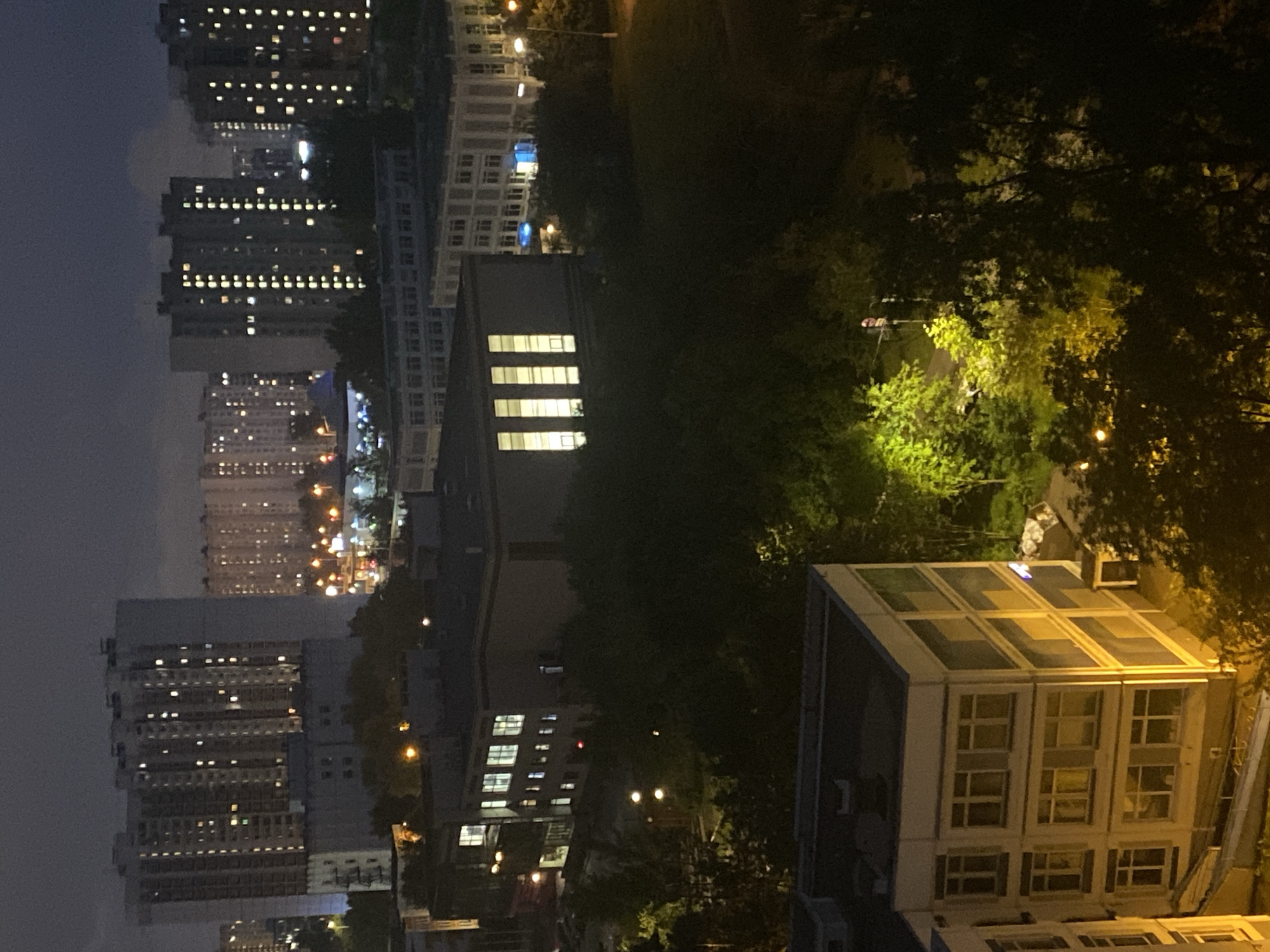 Khimki apartment blocks at night, TV glowing indoors