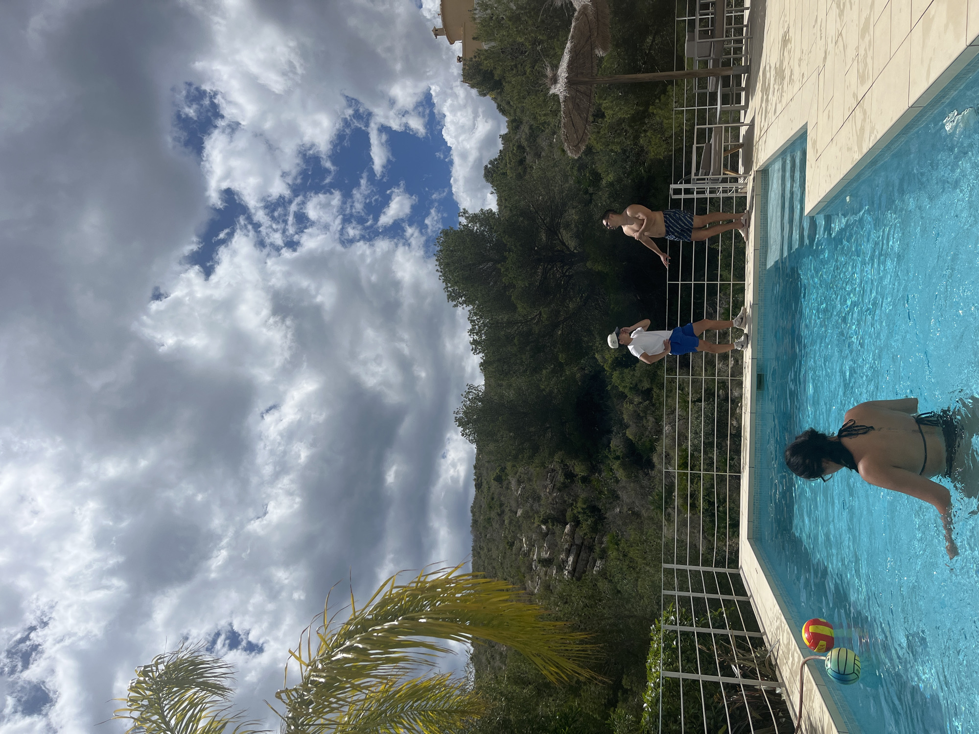 Pool gathering with water games in Spanish coastal town