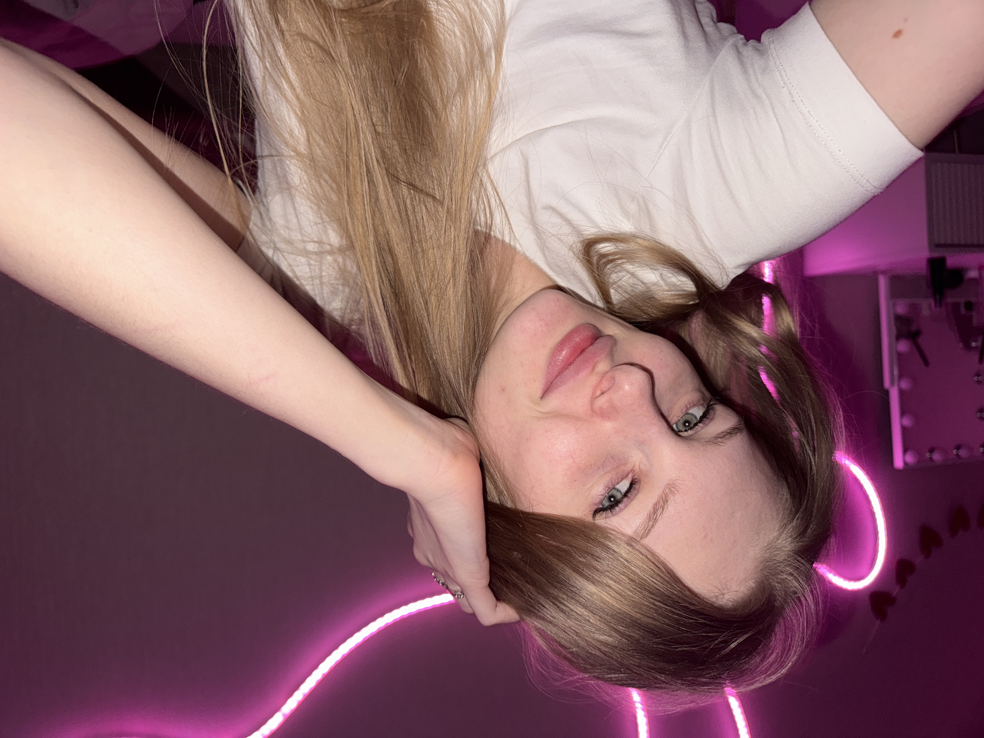 Young woman photographs herself in bedroom in Perm, Russia