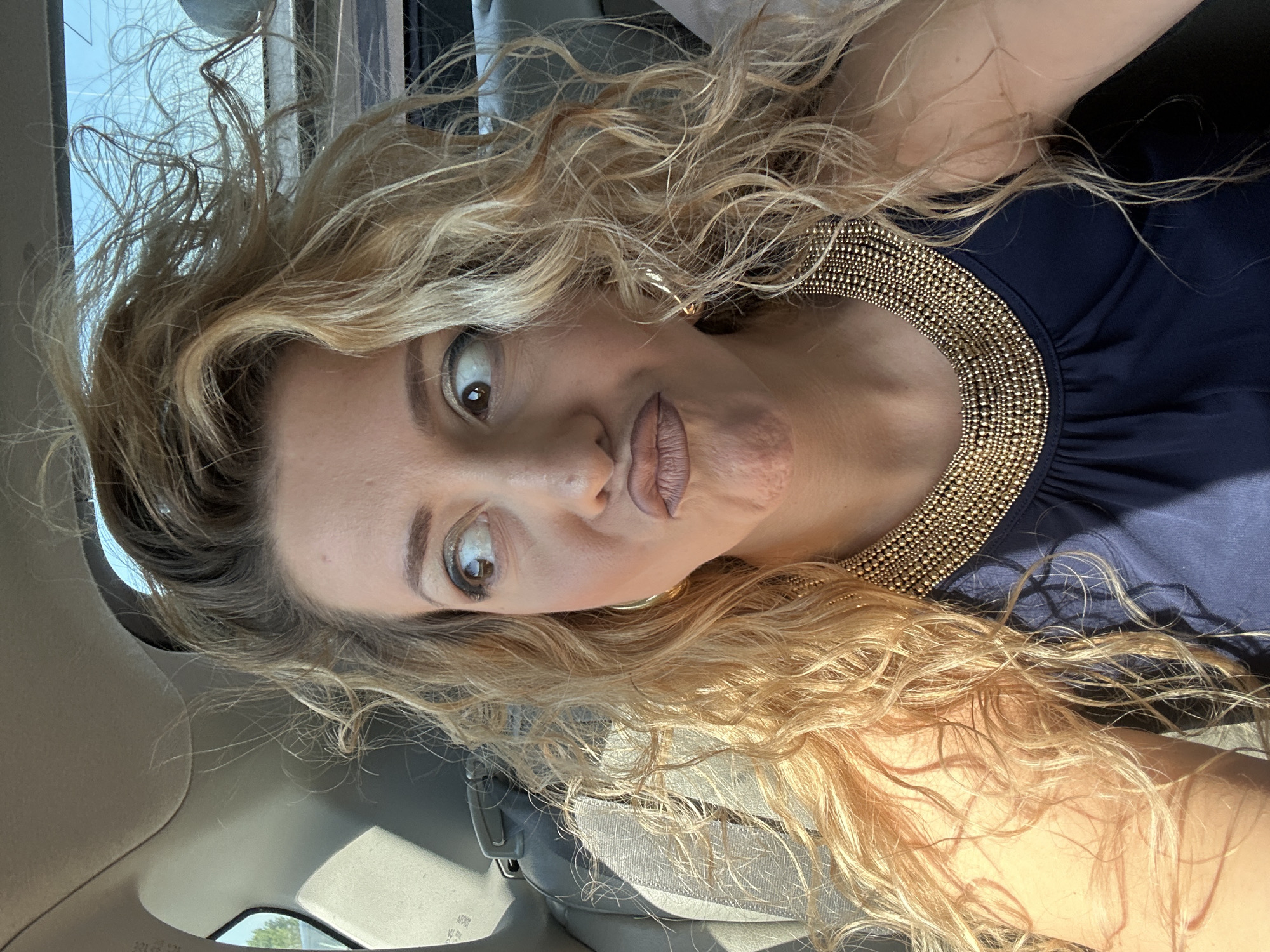 Woman takes selfie during scenic Miata drive near Muiden