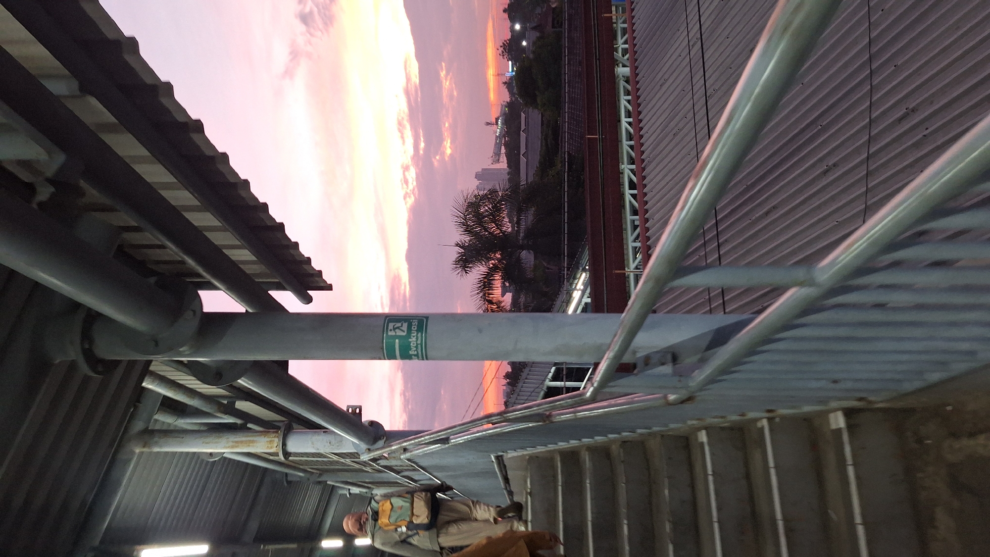 Man photographed on staircase during sunset in North Jakarta