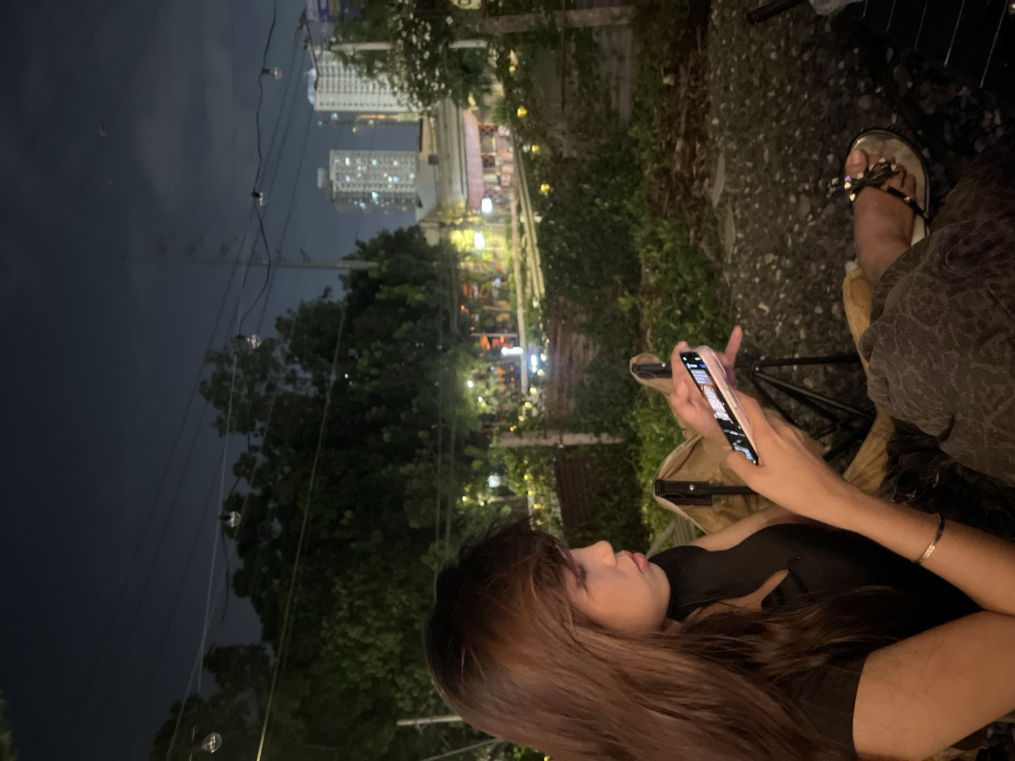 Nighttime drinks and phone time at a Davao outdoor café
