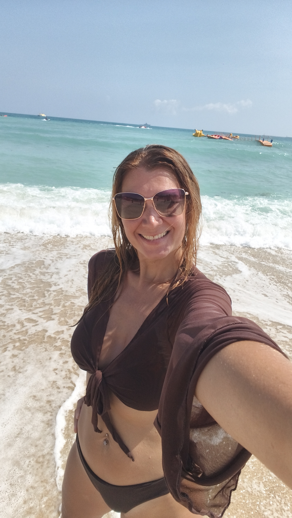 Woman takes beach selfies in Hainan, China early morning