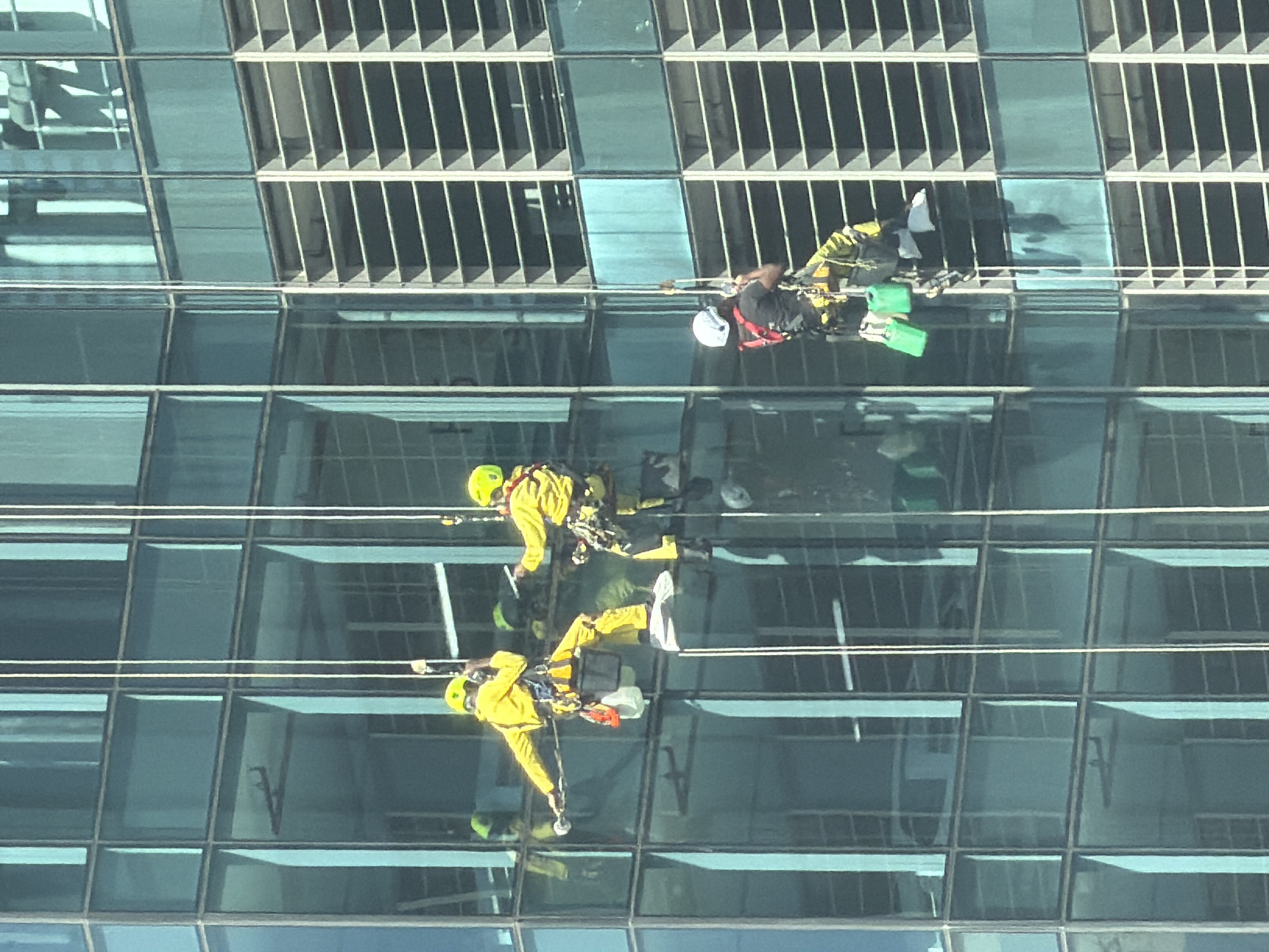 Workers clean windows on Cape Town high-rise building