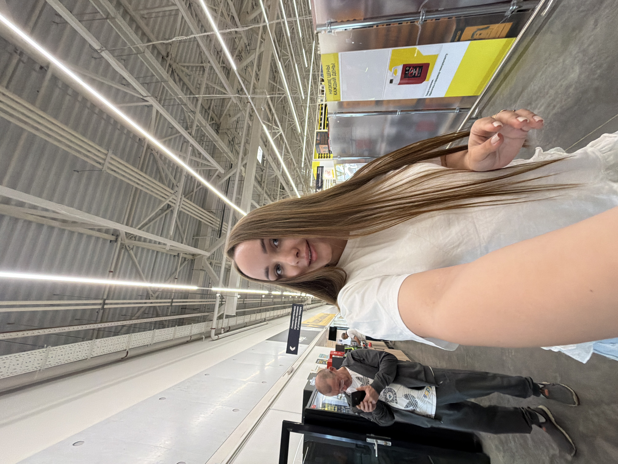 Woman documents shopping trip at Izhevsk warehouse store