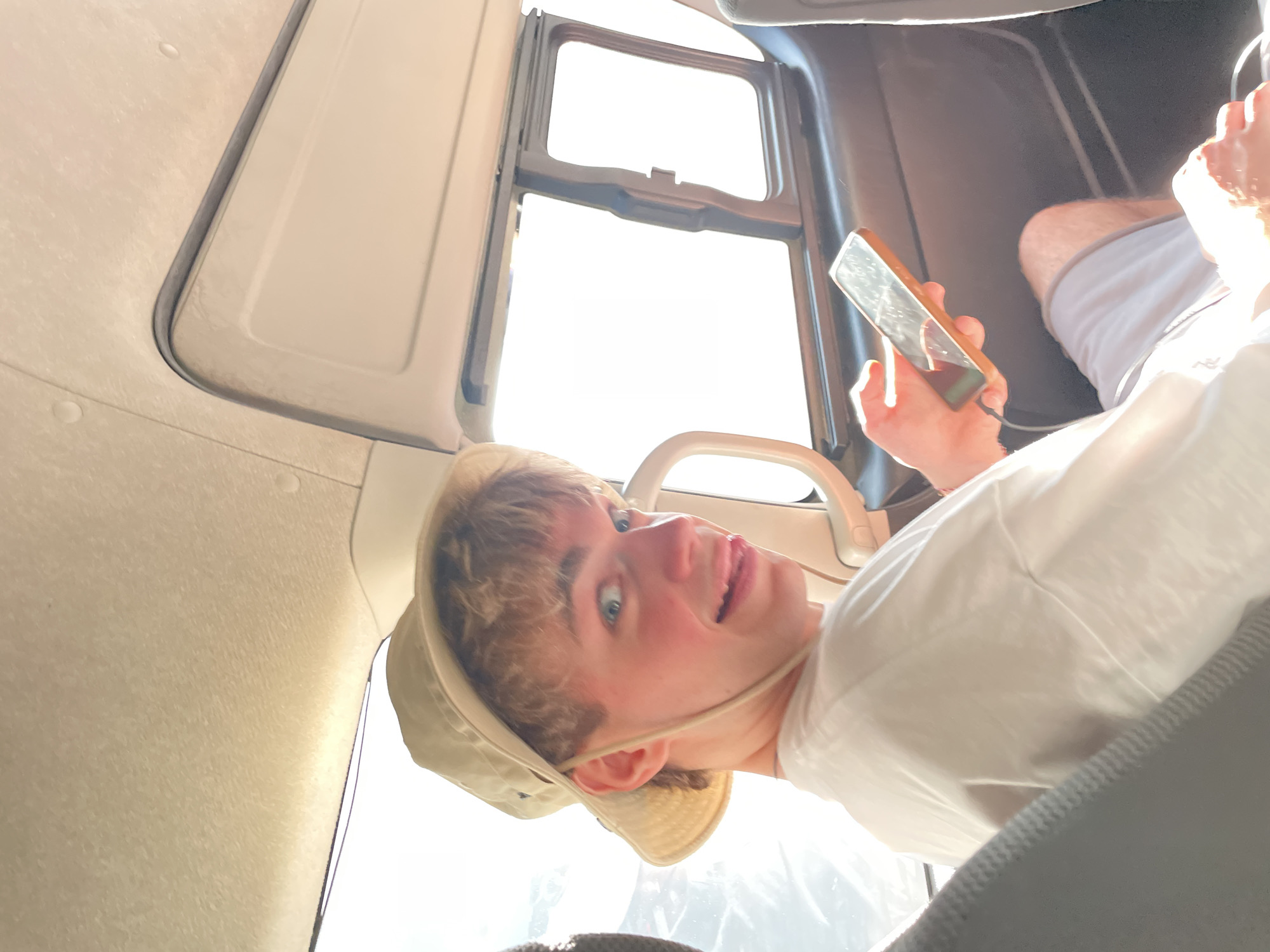 Young person uses smartphone in vehicle in Melaya, Indonesia