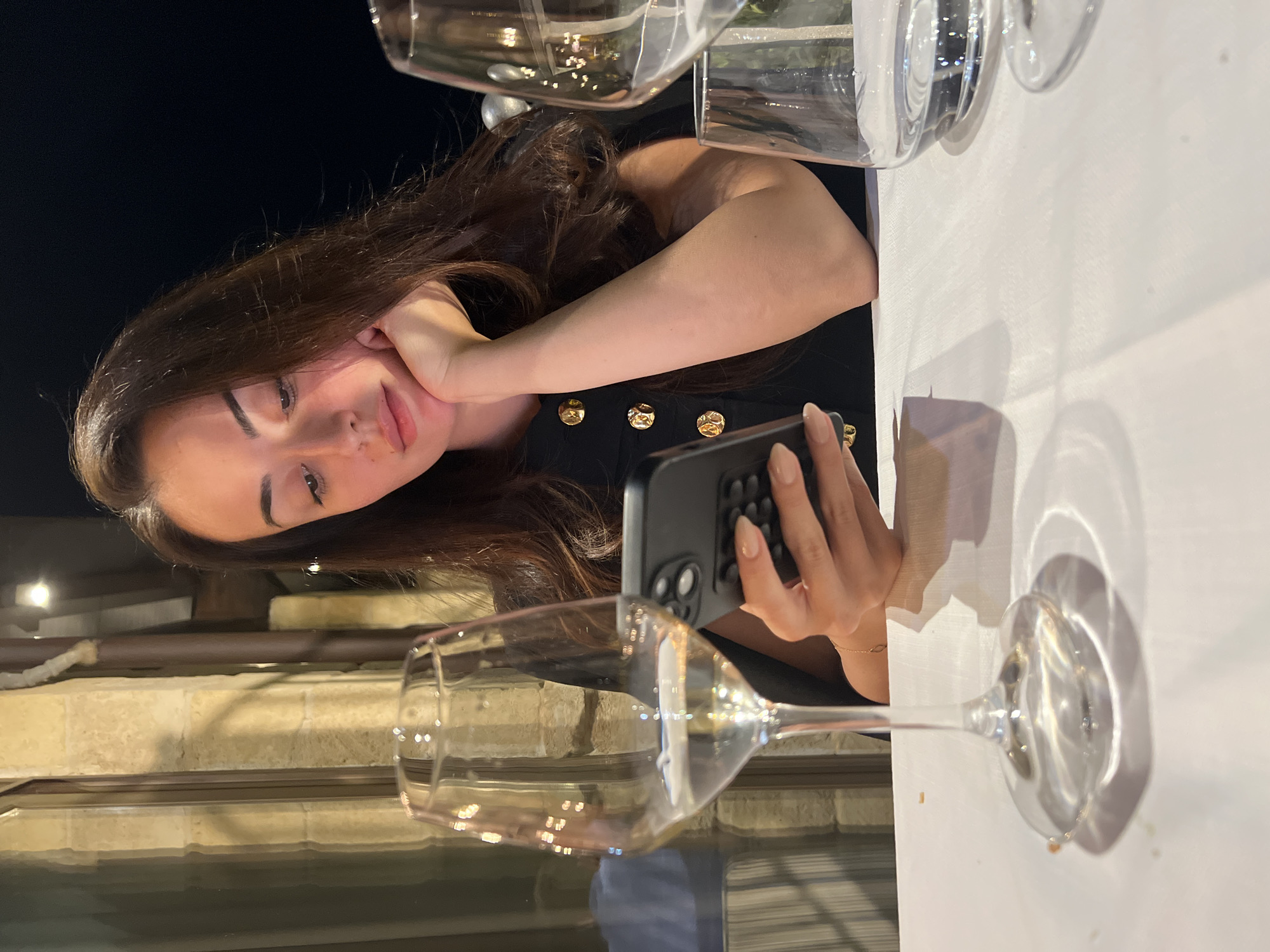 Woman enjoys quiet evening moment in Polignano a Mare