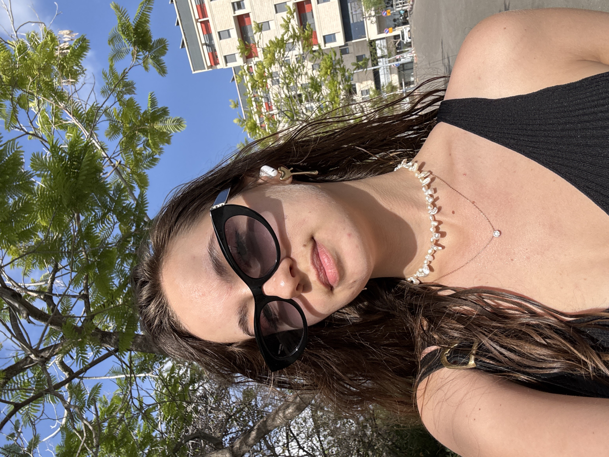 Woman with guitar hair clip photographed outdoors in Tel Aviv