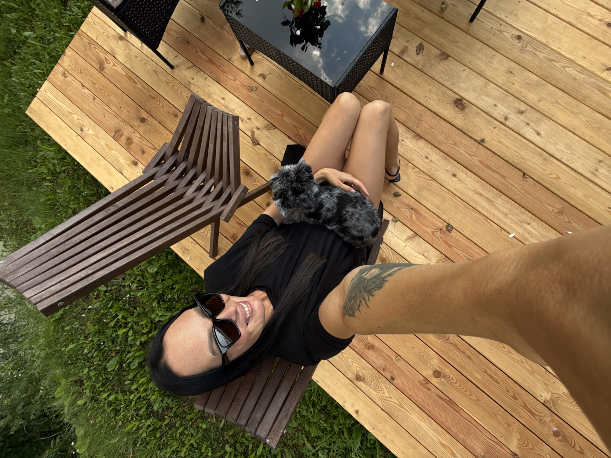Lazy afternoon on a deck in Chaikovsky with a small gray dog