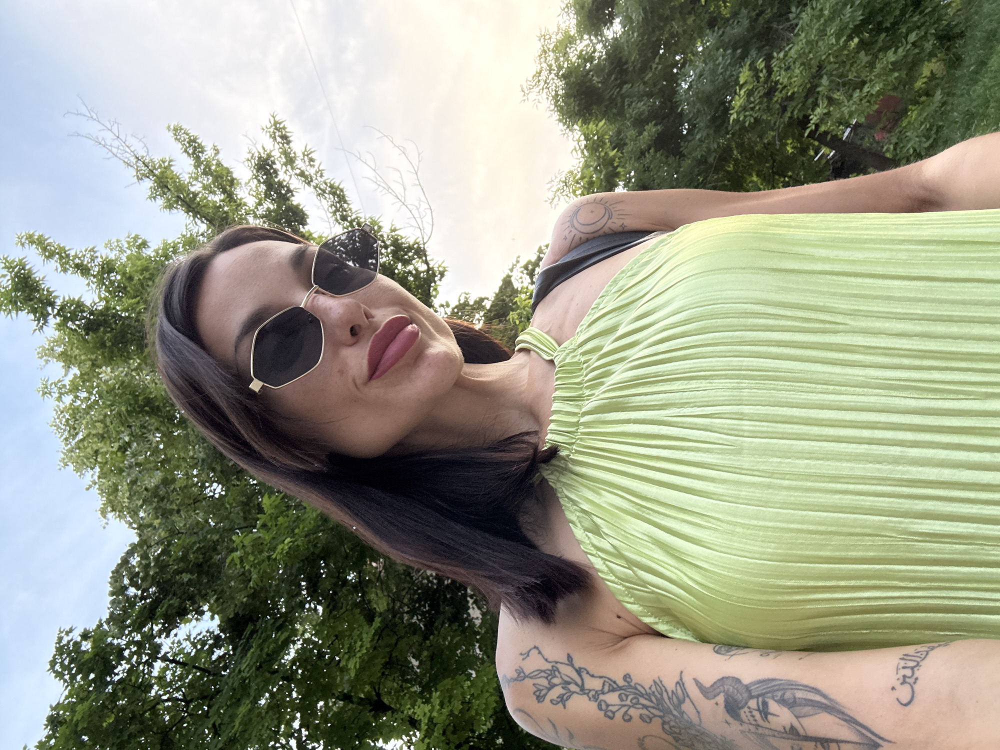 Woman takes multiple selfies in green dress around Pleven