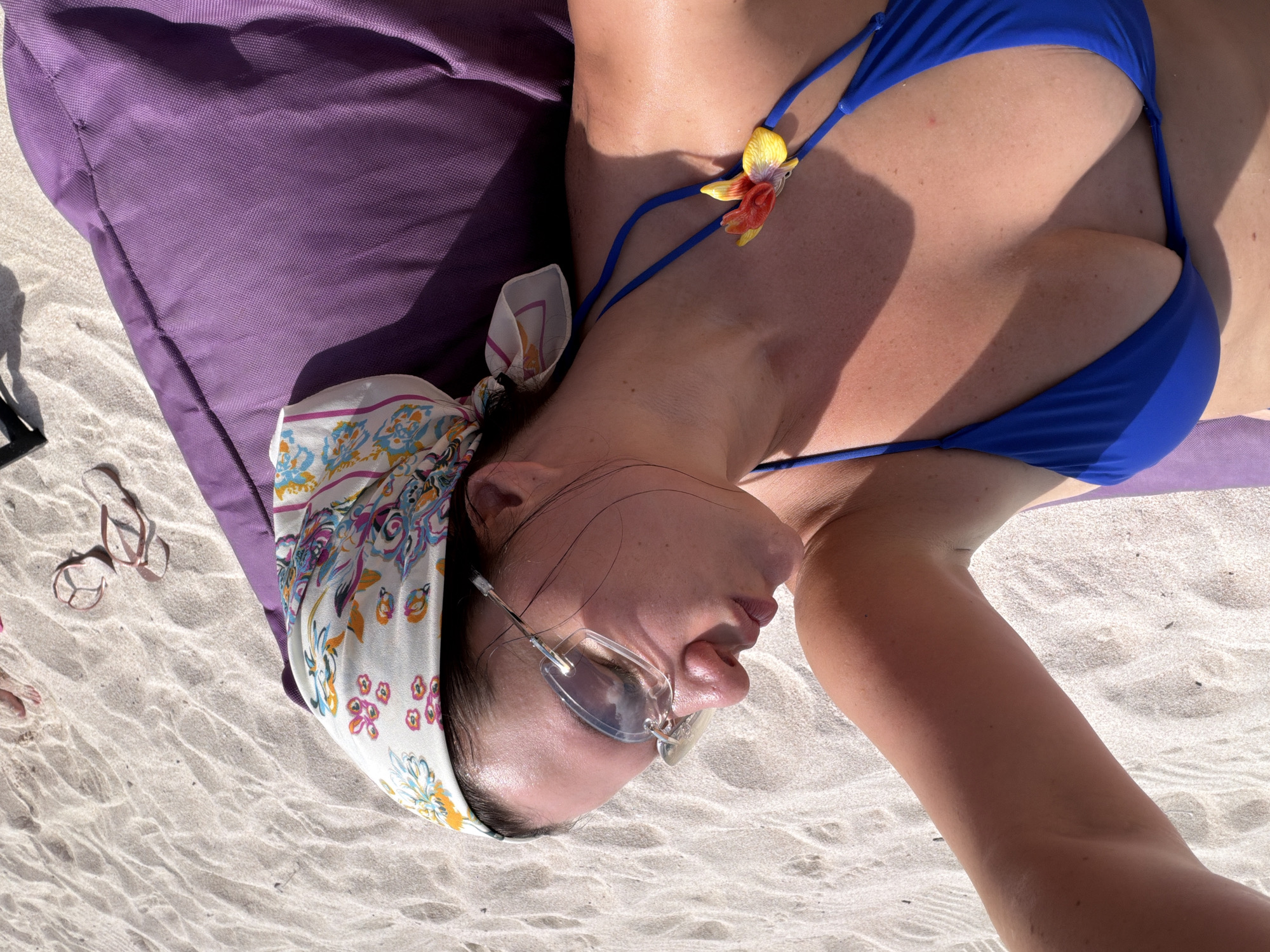 Woman rests on beach in Nusa Penida Indonesia