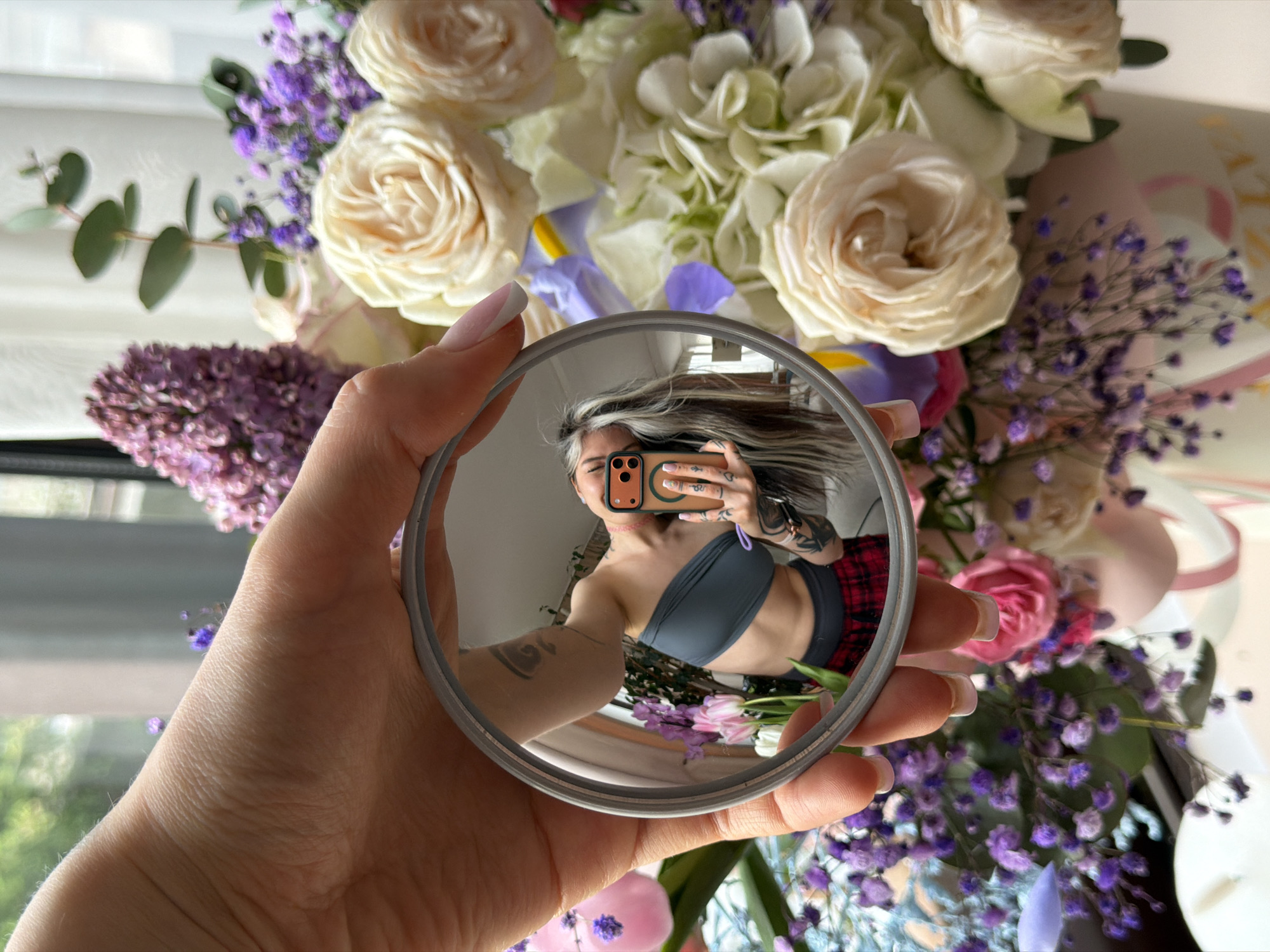 Person Takes Creative Mirror Selfie with Flowers in Budva