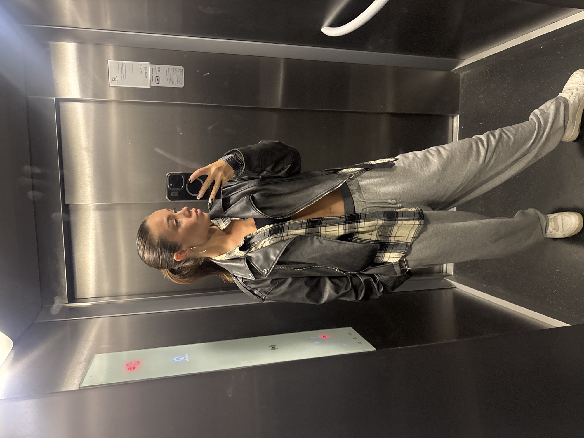 Woman documents rainy morning with elevator selfies in Budva