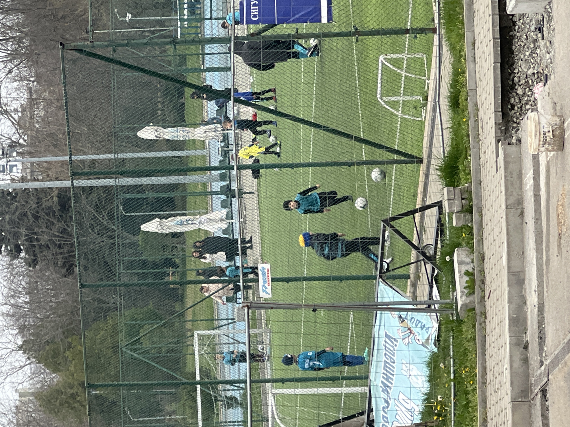Youth soccer game and park pathway observed in Burgas