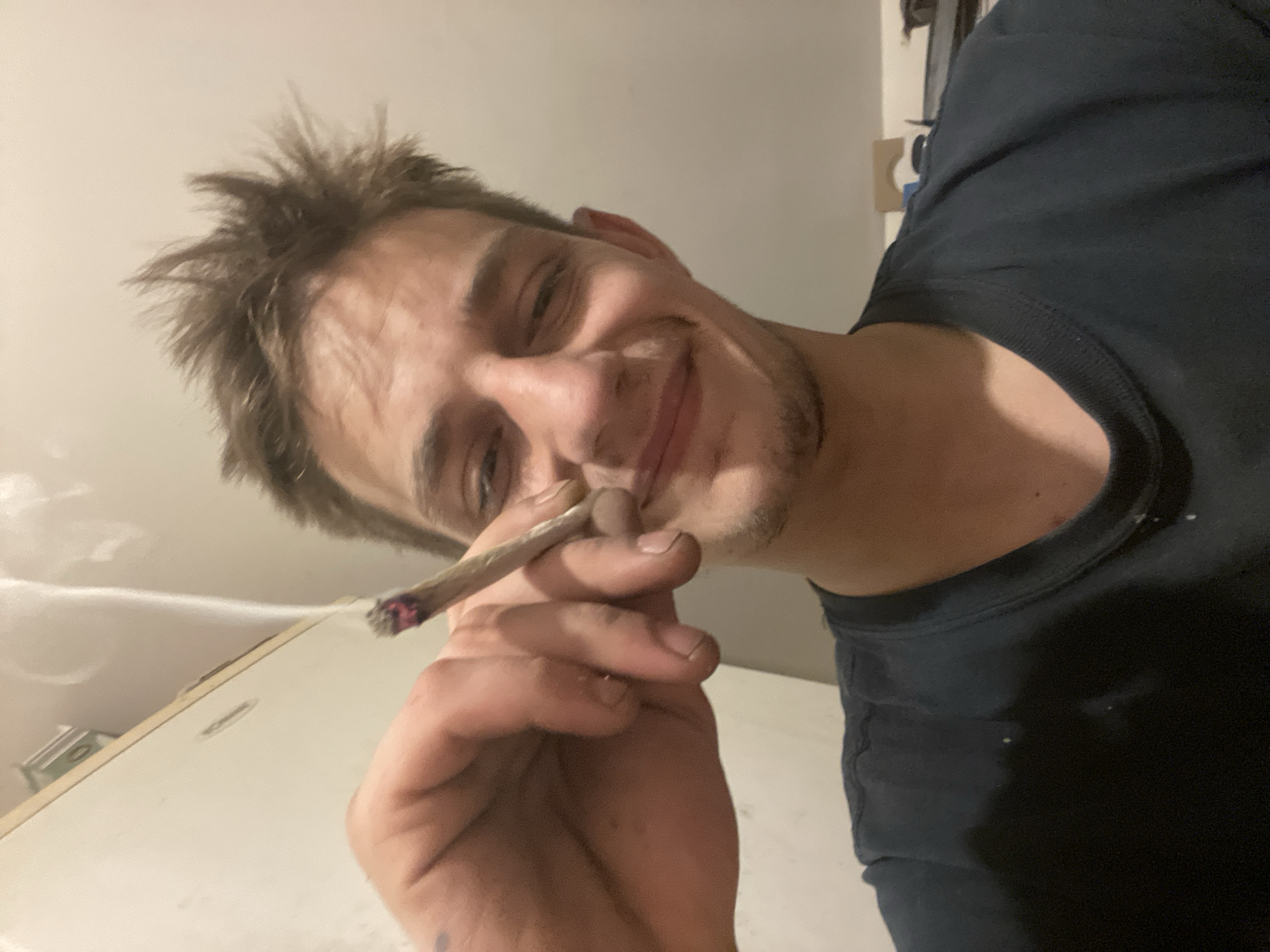 Rolling and smoking marijuana, close-up and casual