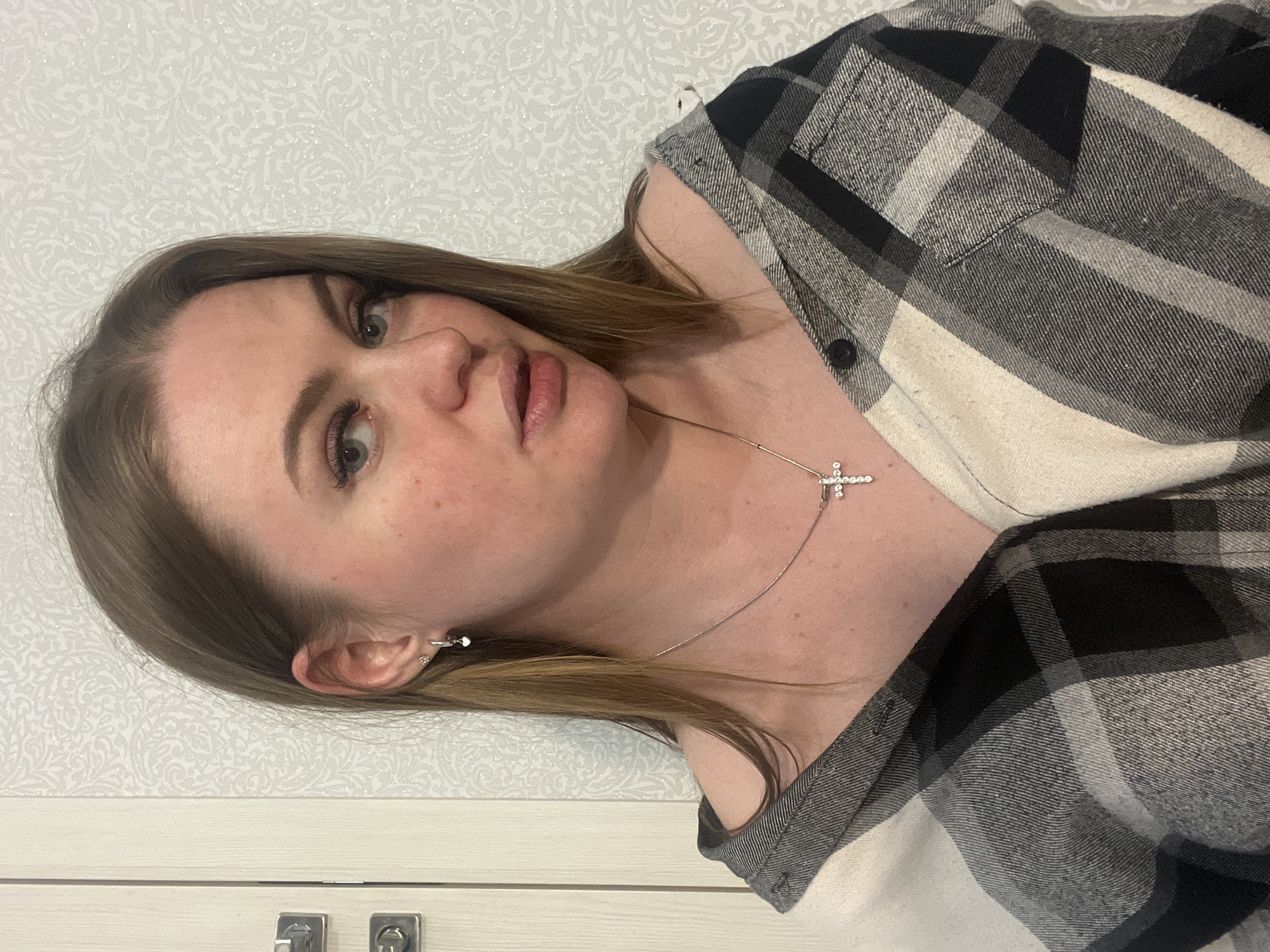 Woman in checkered shirt observed indoors in Sevastopol