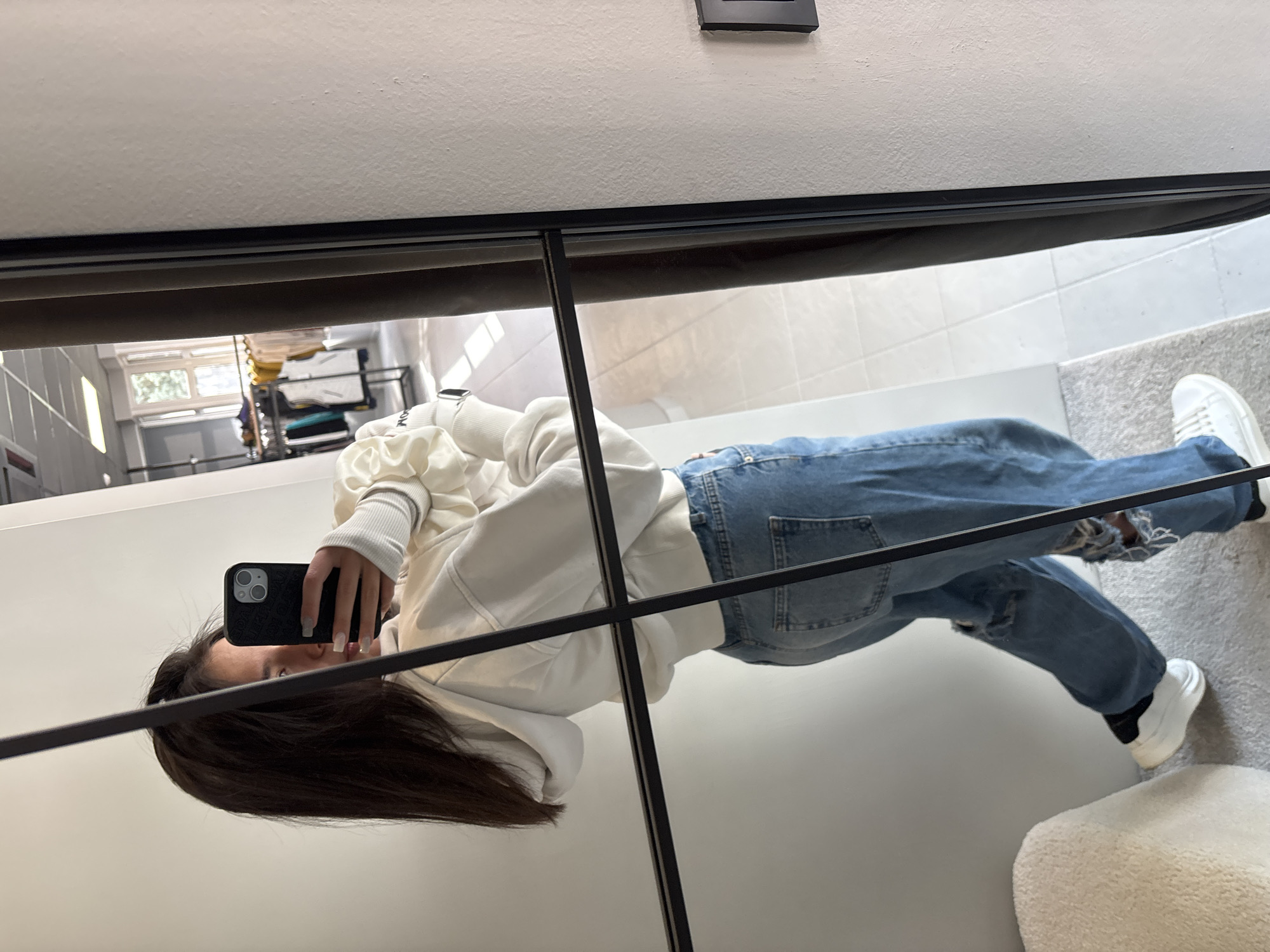 Woman takes mirror selfie in Gabrovo retail location
