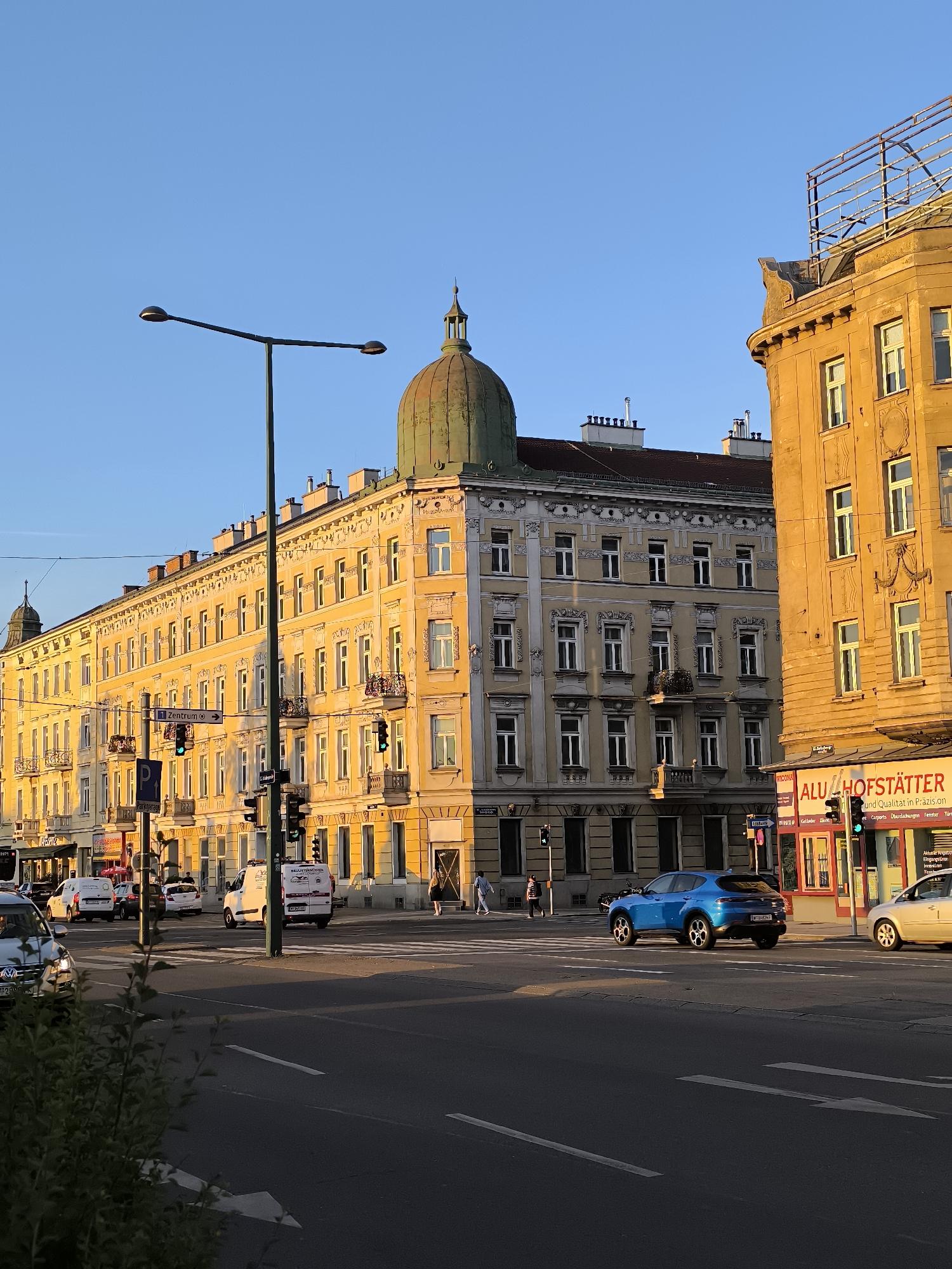 Golden hour illuminates Vienna street intersection buildings