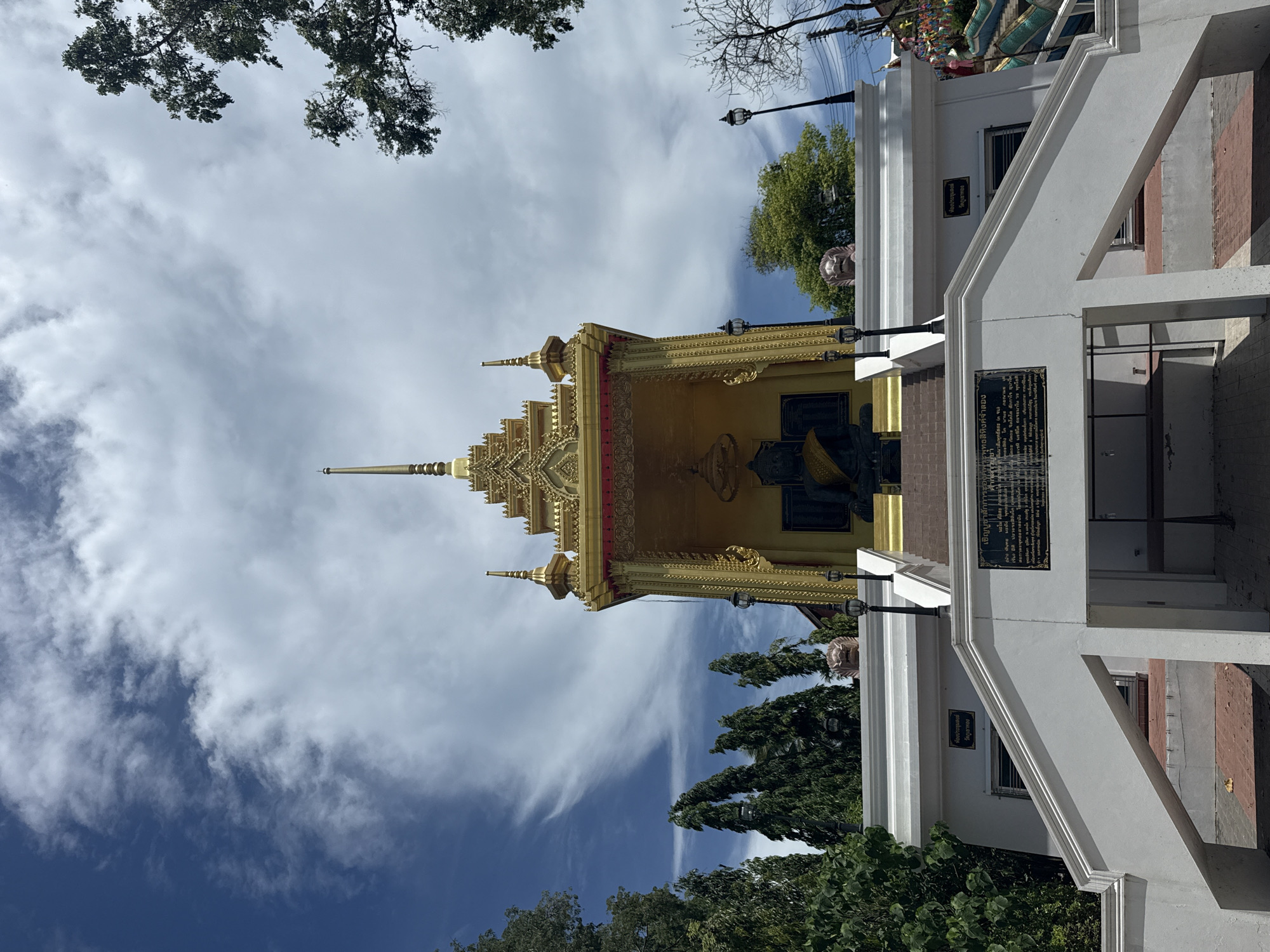 Golden temple with dark statue photographed in Baan Mae Nam