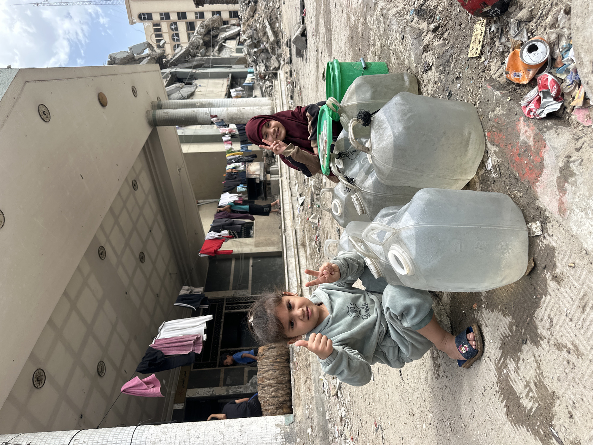 Gaza children play, collect water amid destruction and displacement